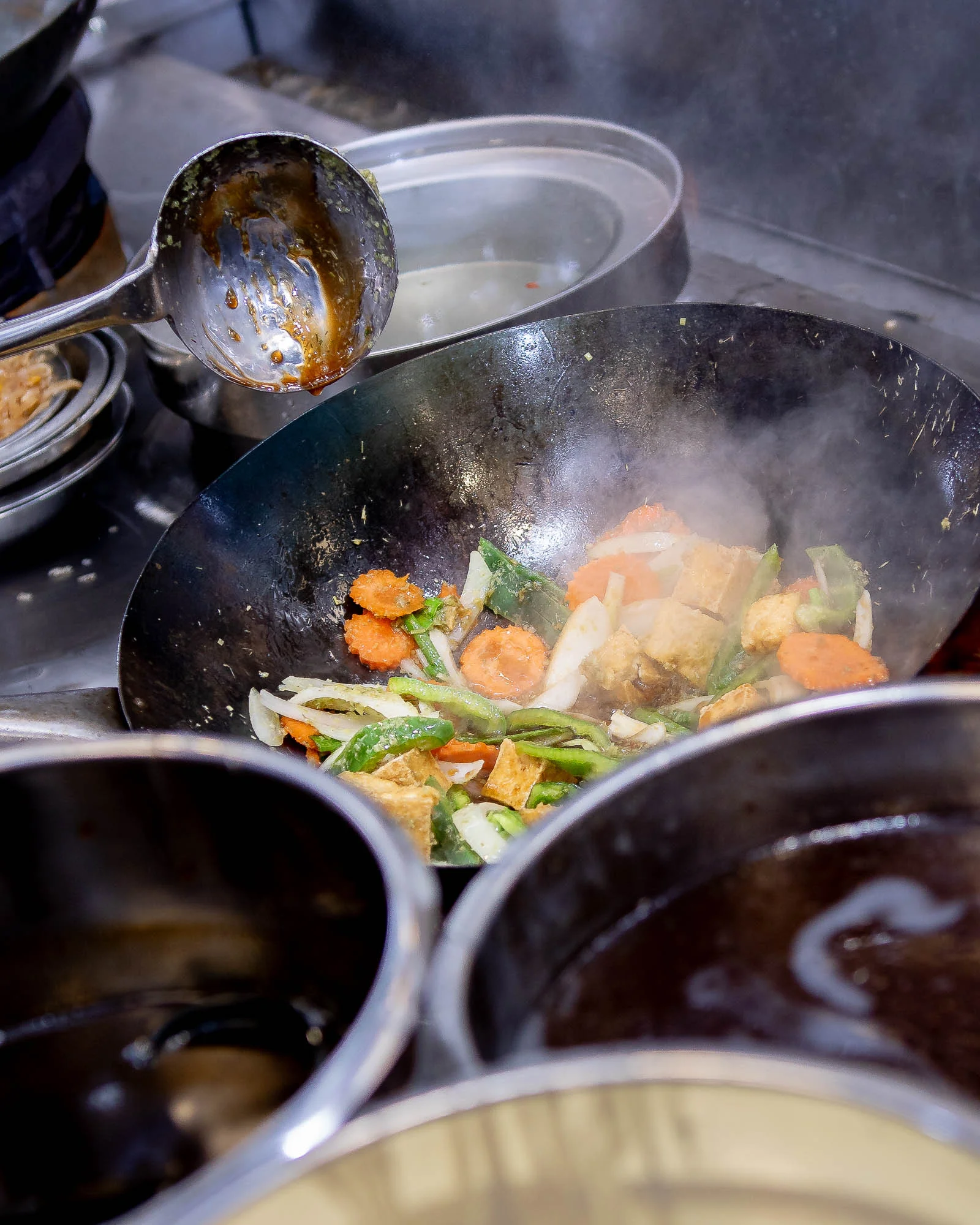 Vegetables being stir-fried in a wok