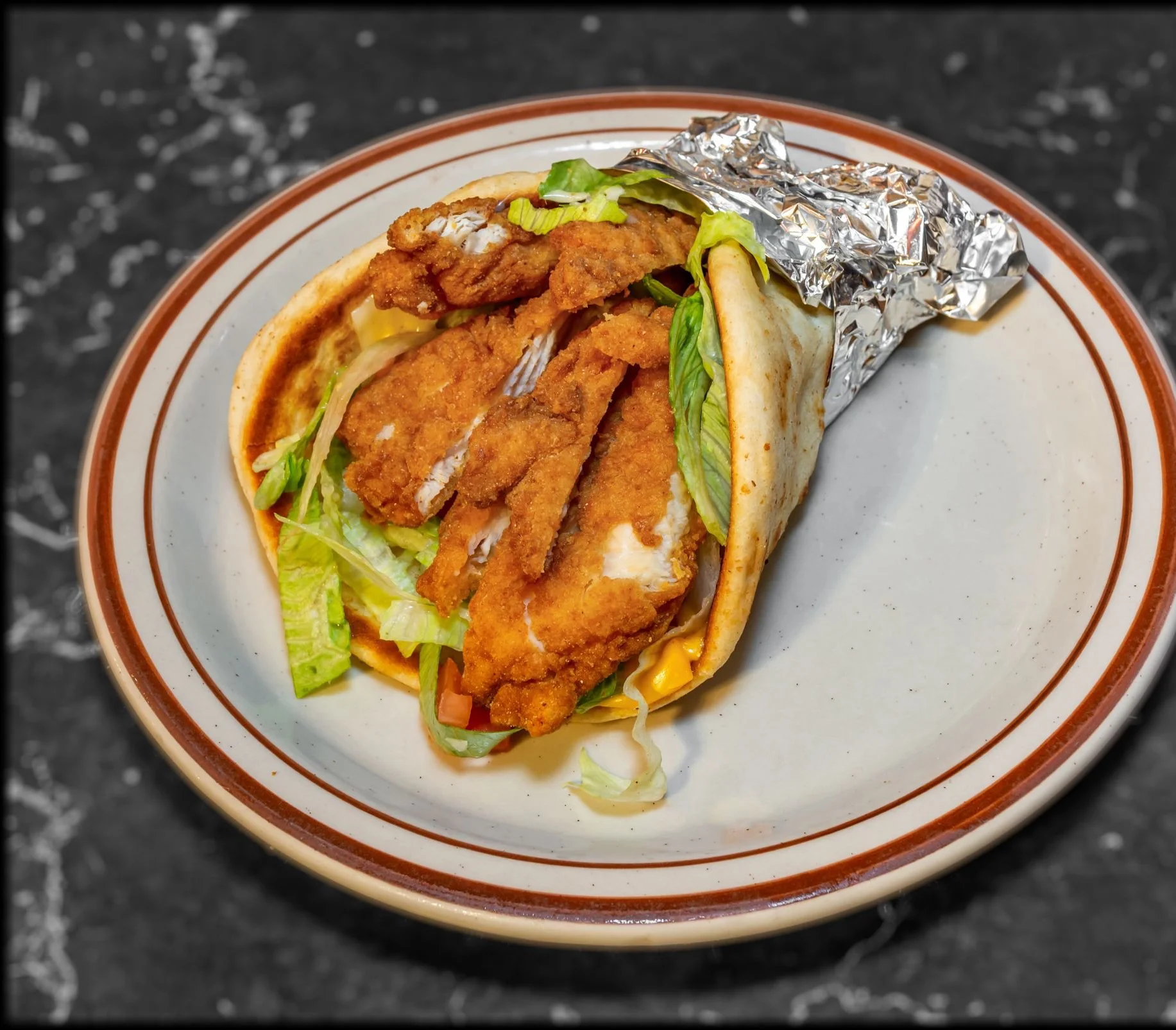 Crispy chicken wrap with lettuce in a soft tortilla