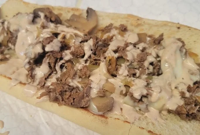 Philly cheesesteak sandwich with sautéed mushrooms