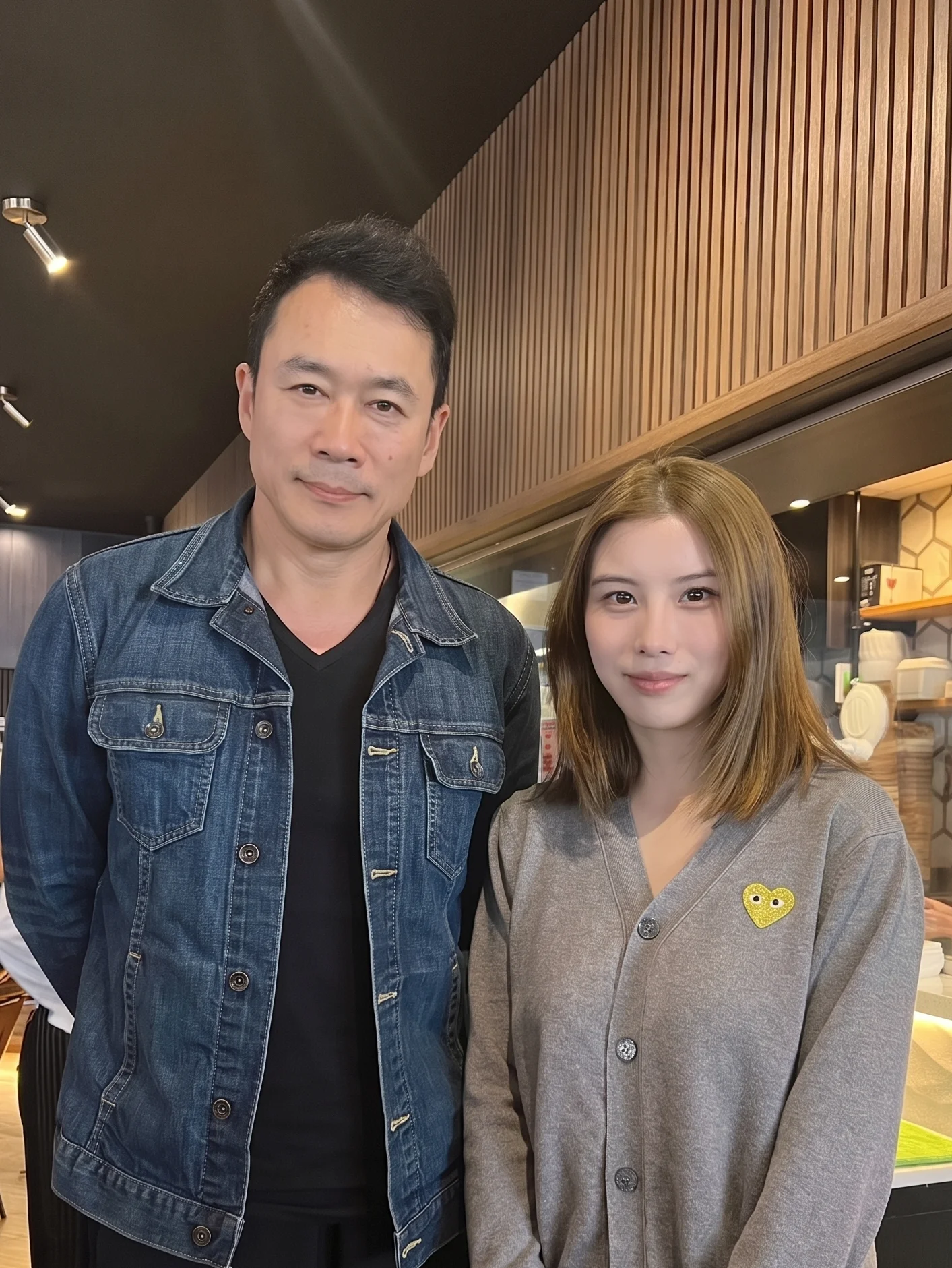 Two people posing in a modern restaurant interior
