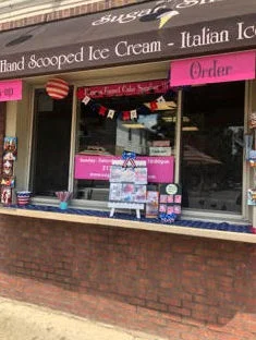 Ice cream shop exterior with colorful signage and ordering window
