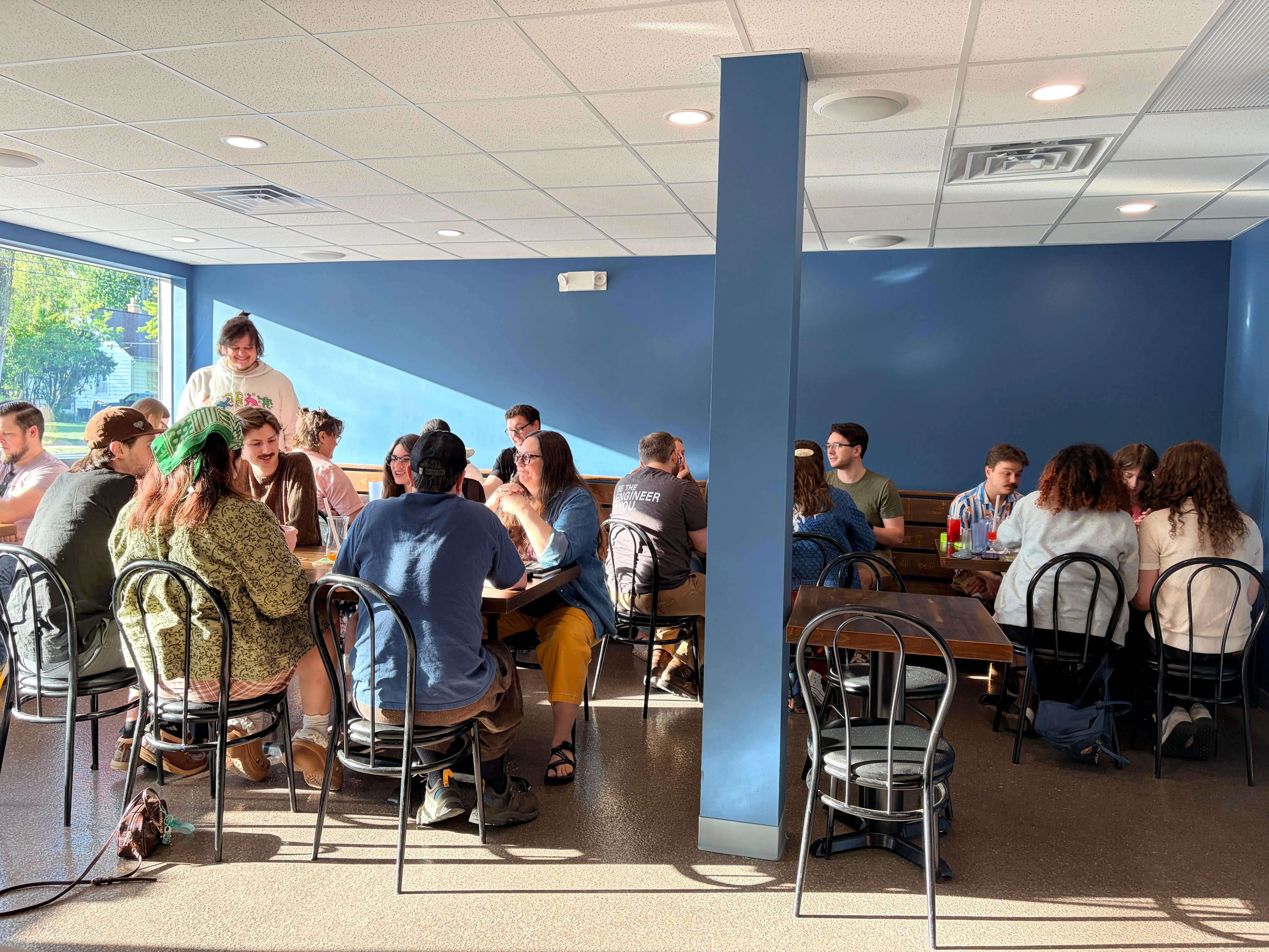 Cozy restaurant interior with diners enjoying meals and natural light