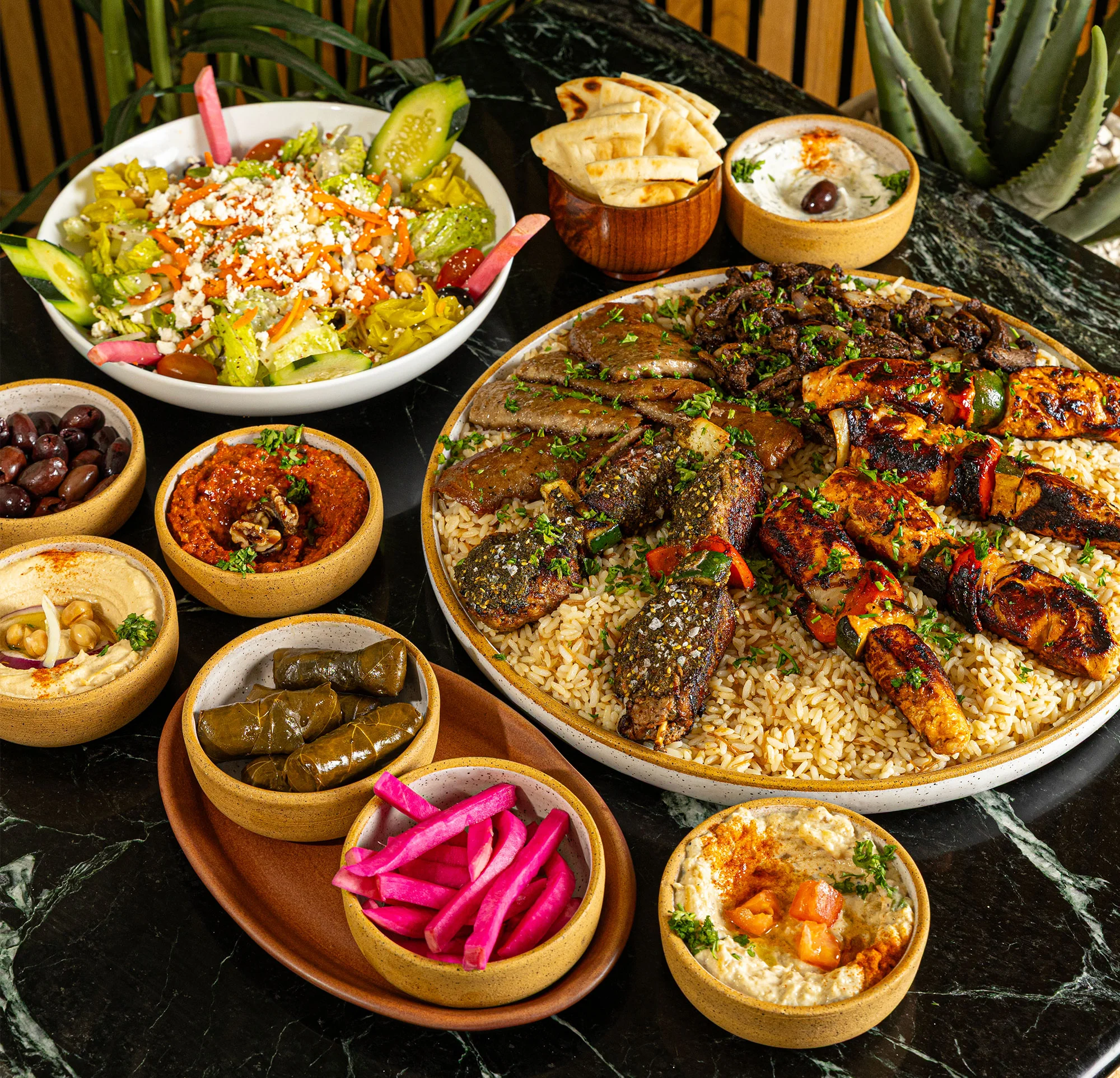 Mediterranean mixed grill platter with rice and assorted dips
