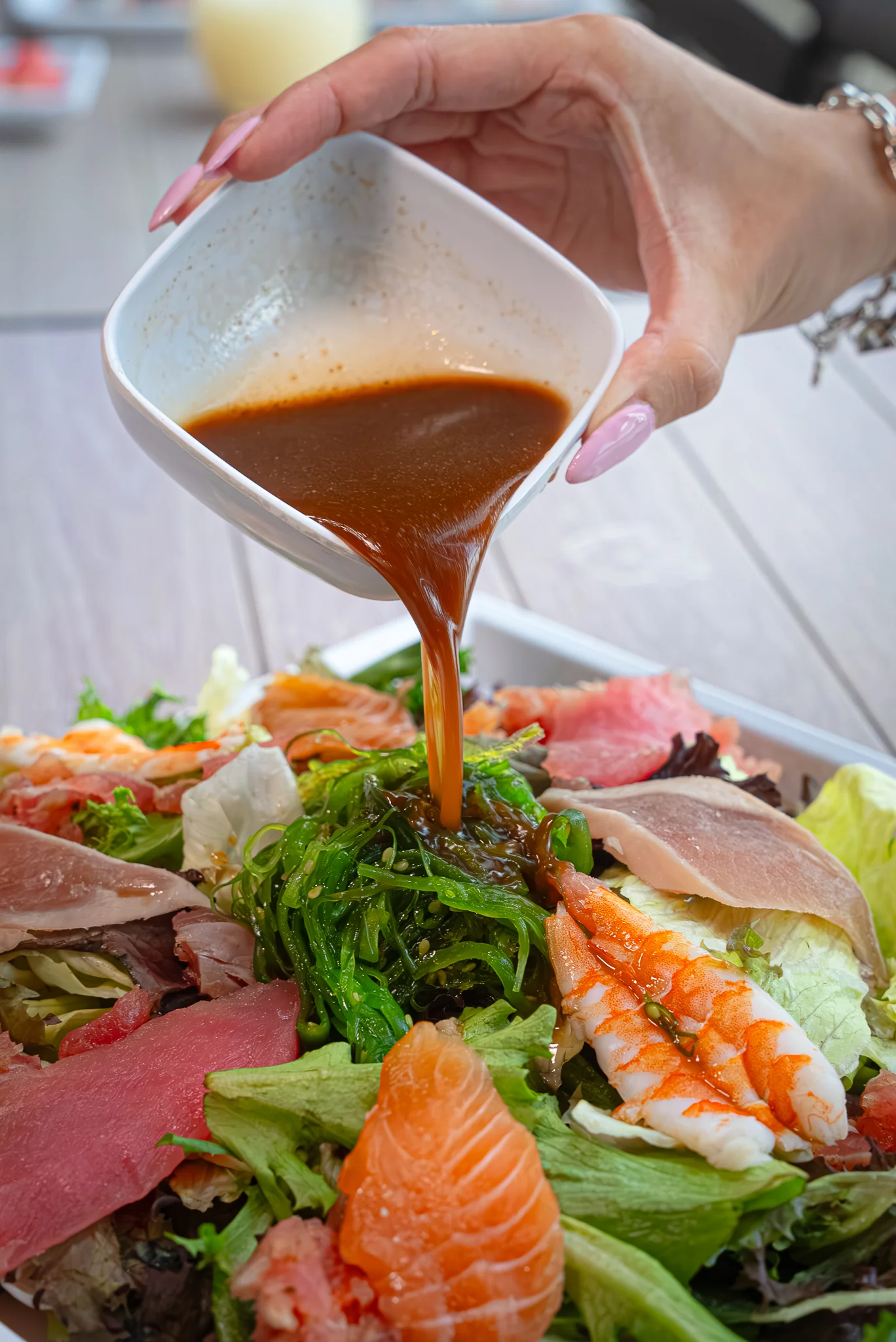 Japanese chirashi sushi salad with seafood and dressing