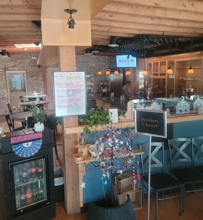 Cozy restaurant interior with wooden beams and a bar area