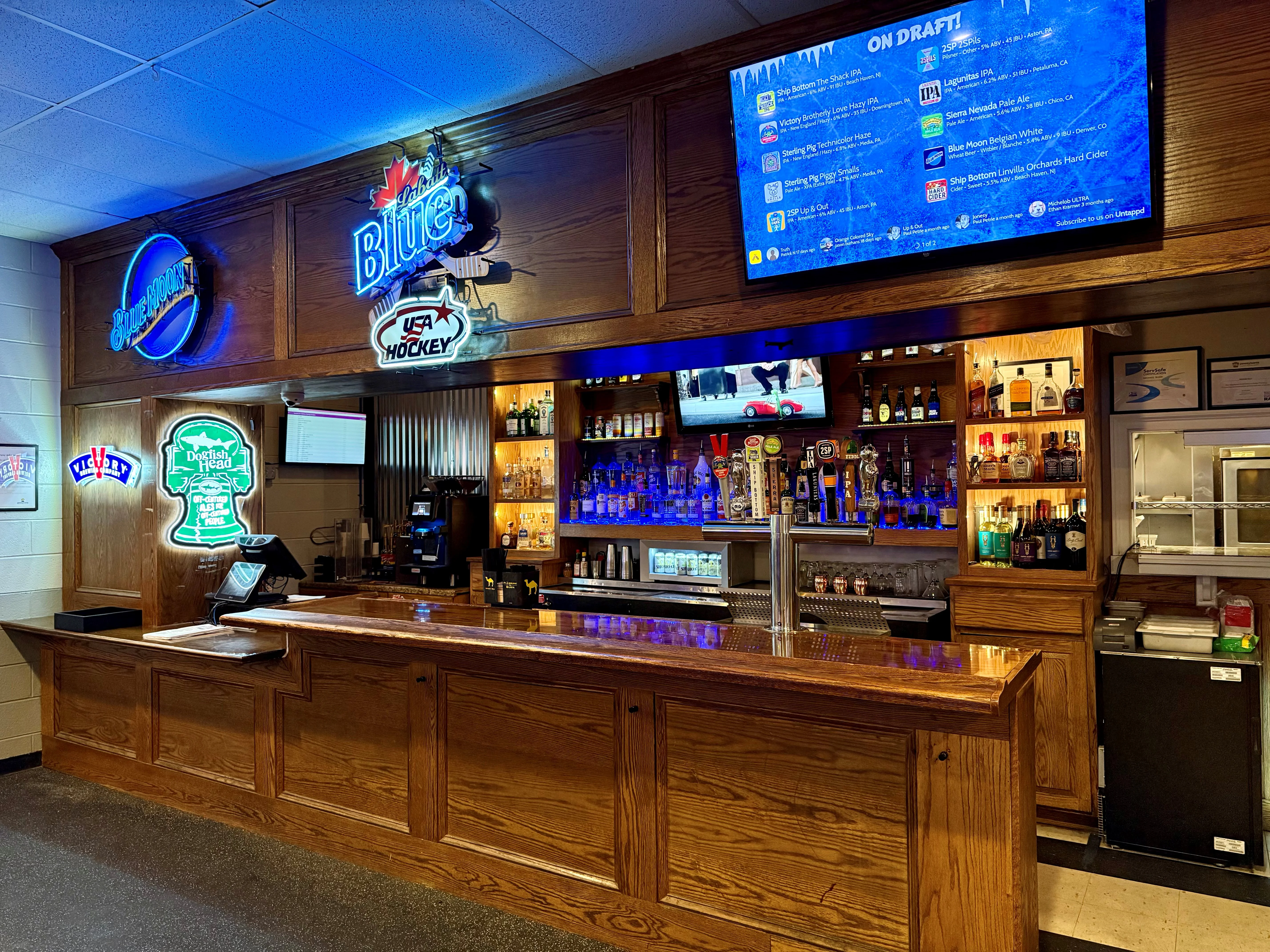 Modern bar counter with neon signs and draft beer selection