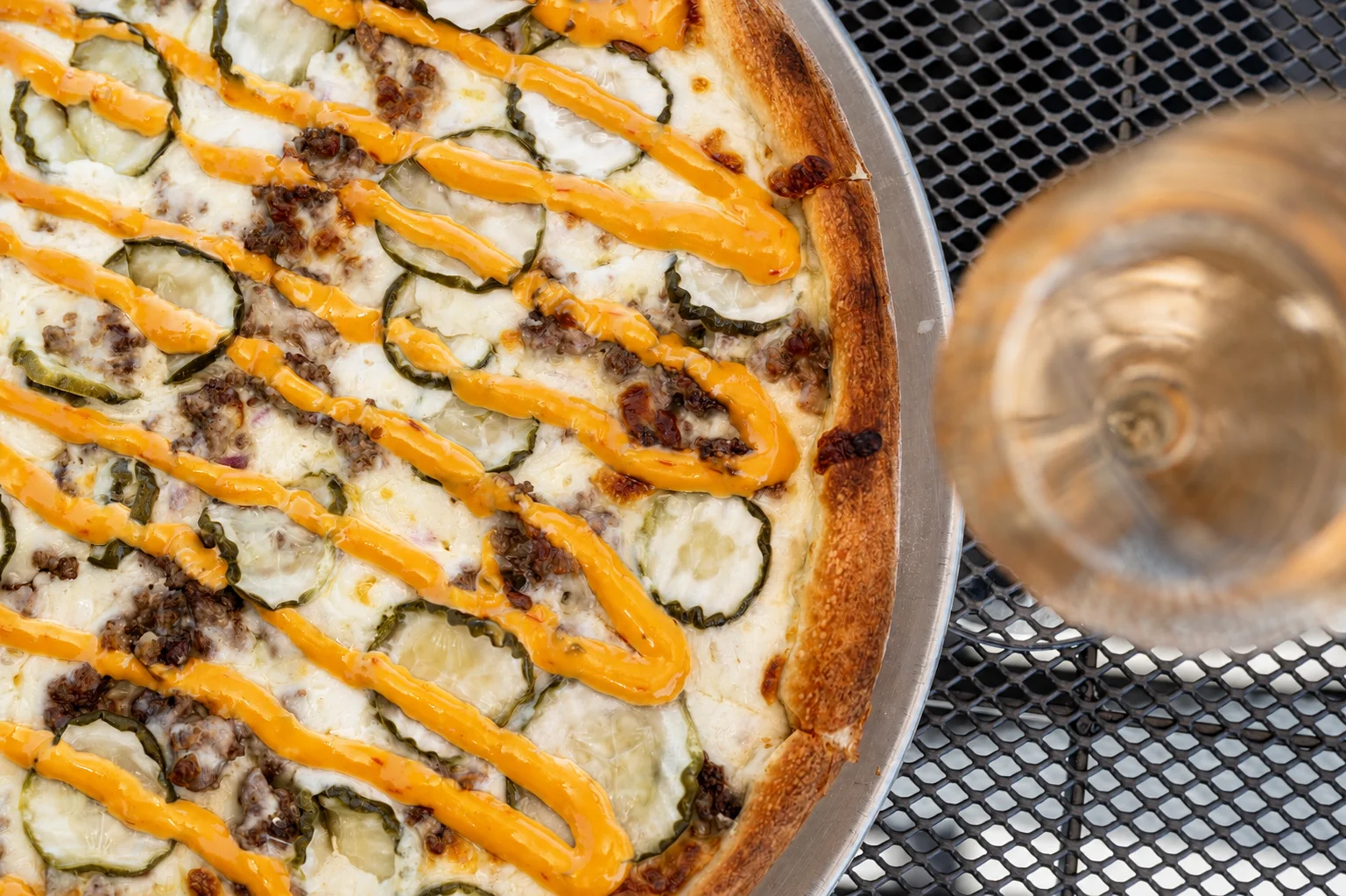 Cheeseburger pizza with pickles and sauce