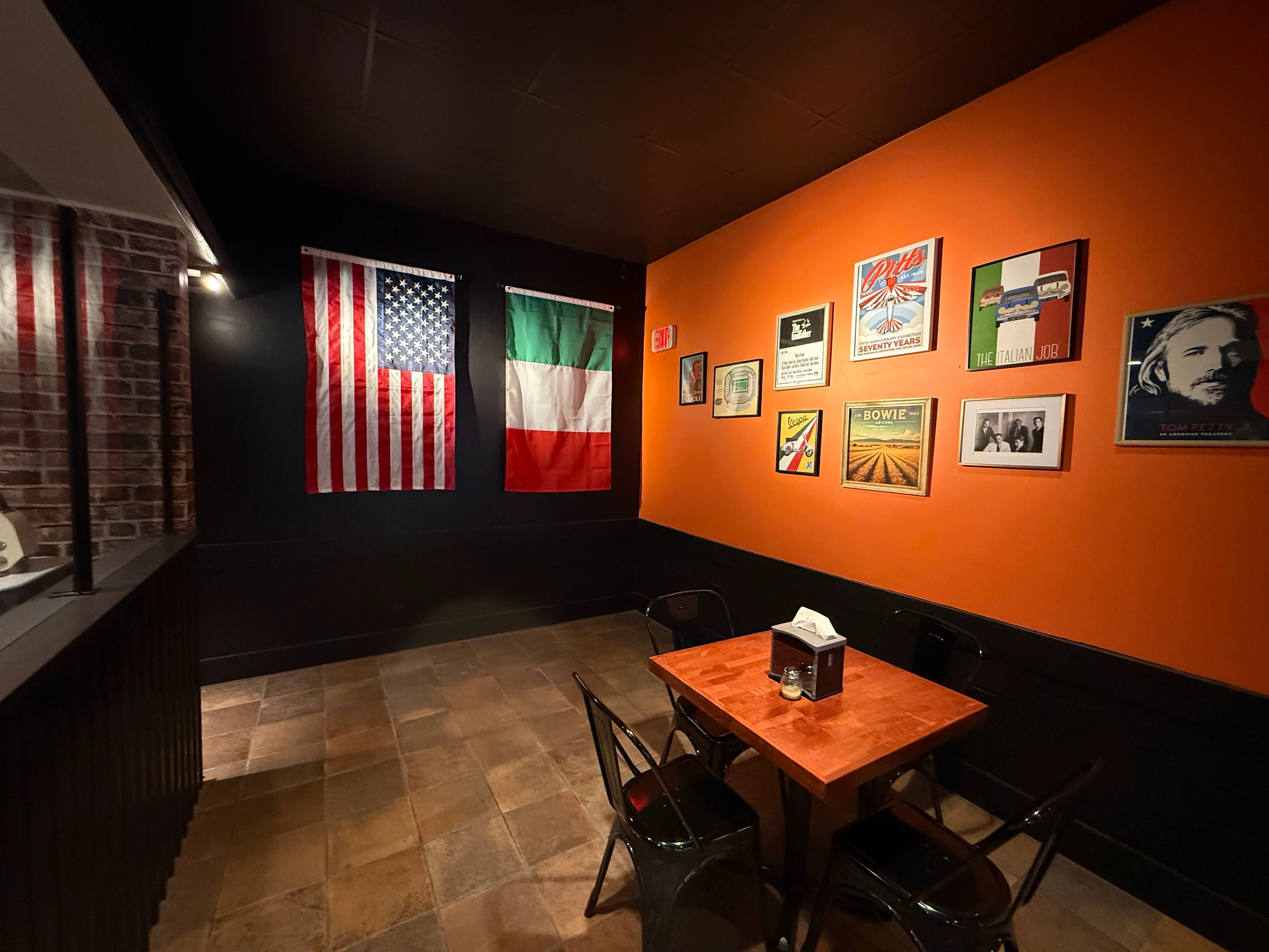 Cozy restaurant interior with American and Italian flags