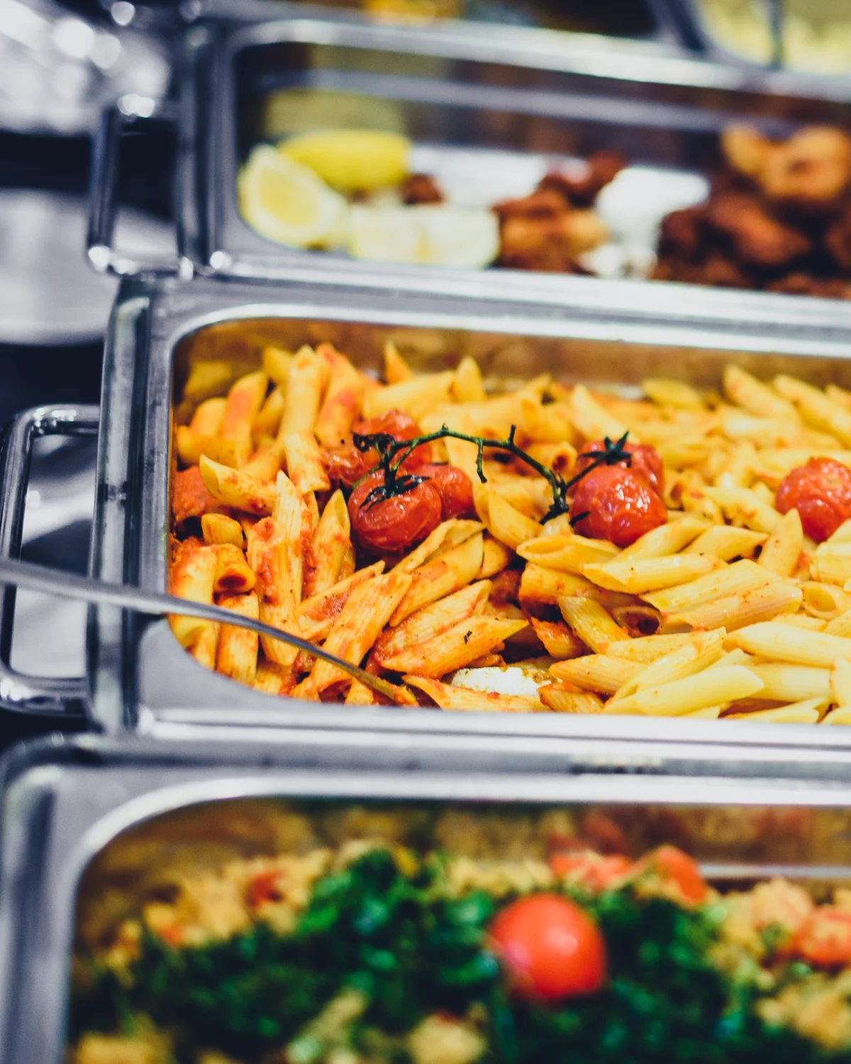Penne arrabbiata with cherry tomatoes in a buffet setting