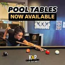 Player enjoying a game of pool at a vibrant bar