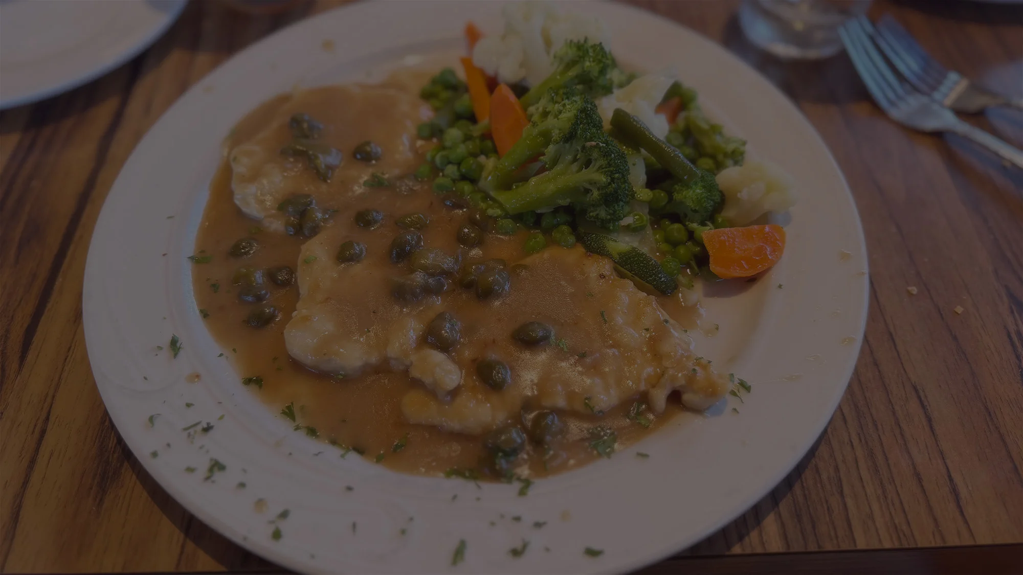 Chicken piccata served with mixed vegetables