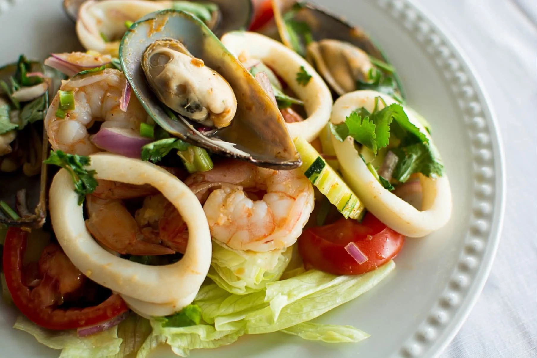 Thai seafood salad with shrimp and calamari on a plate