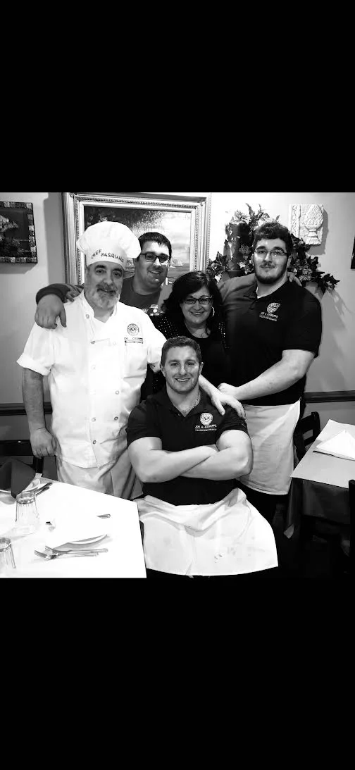 Family team at an Italian restaurant celebrating together