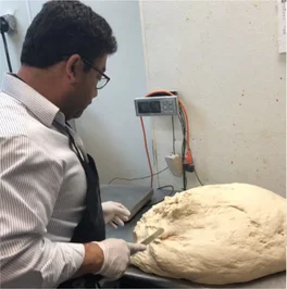 Baker preparing dough for artisan bread