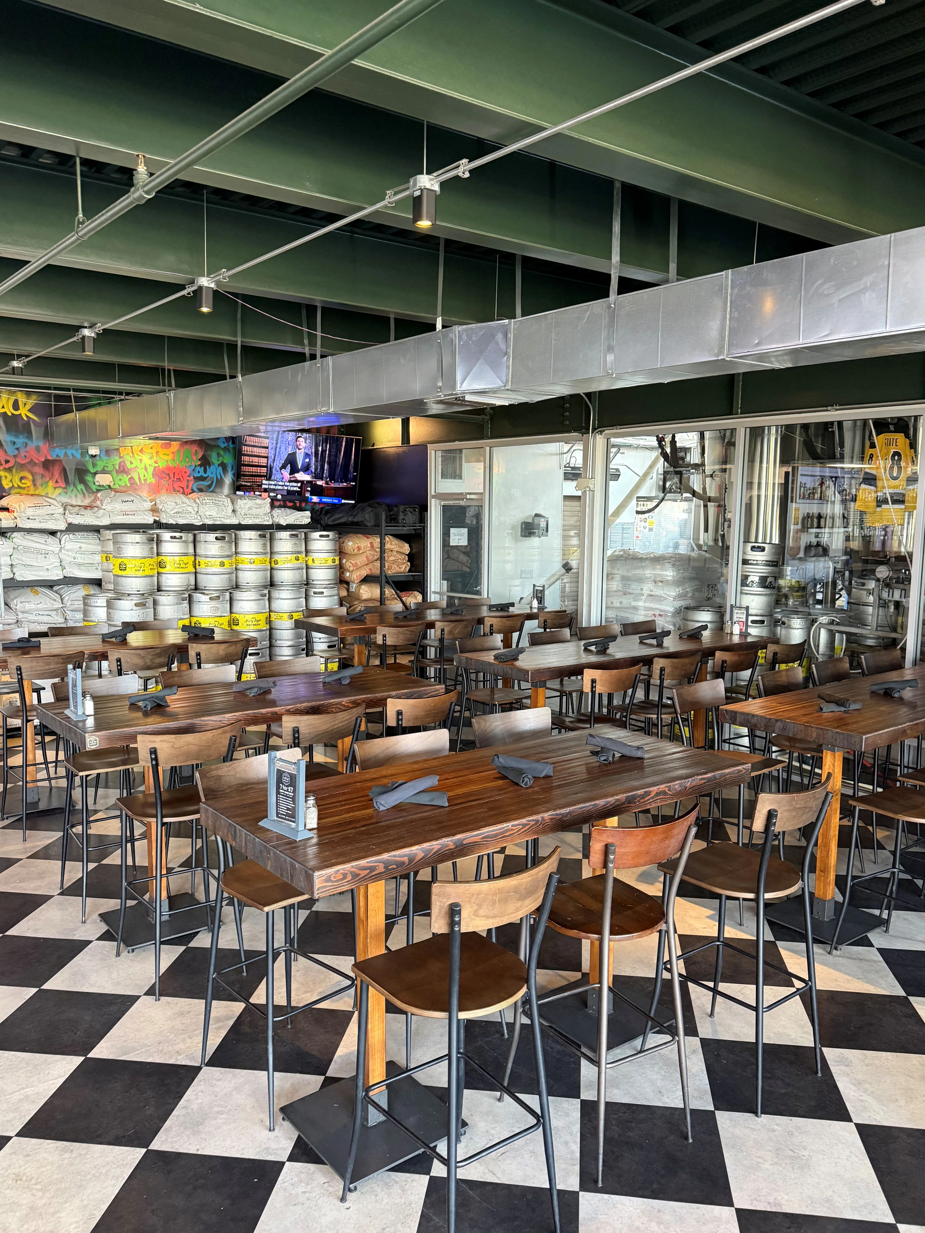 Modern restaurant interior with wooden tables and industrial decor
