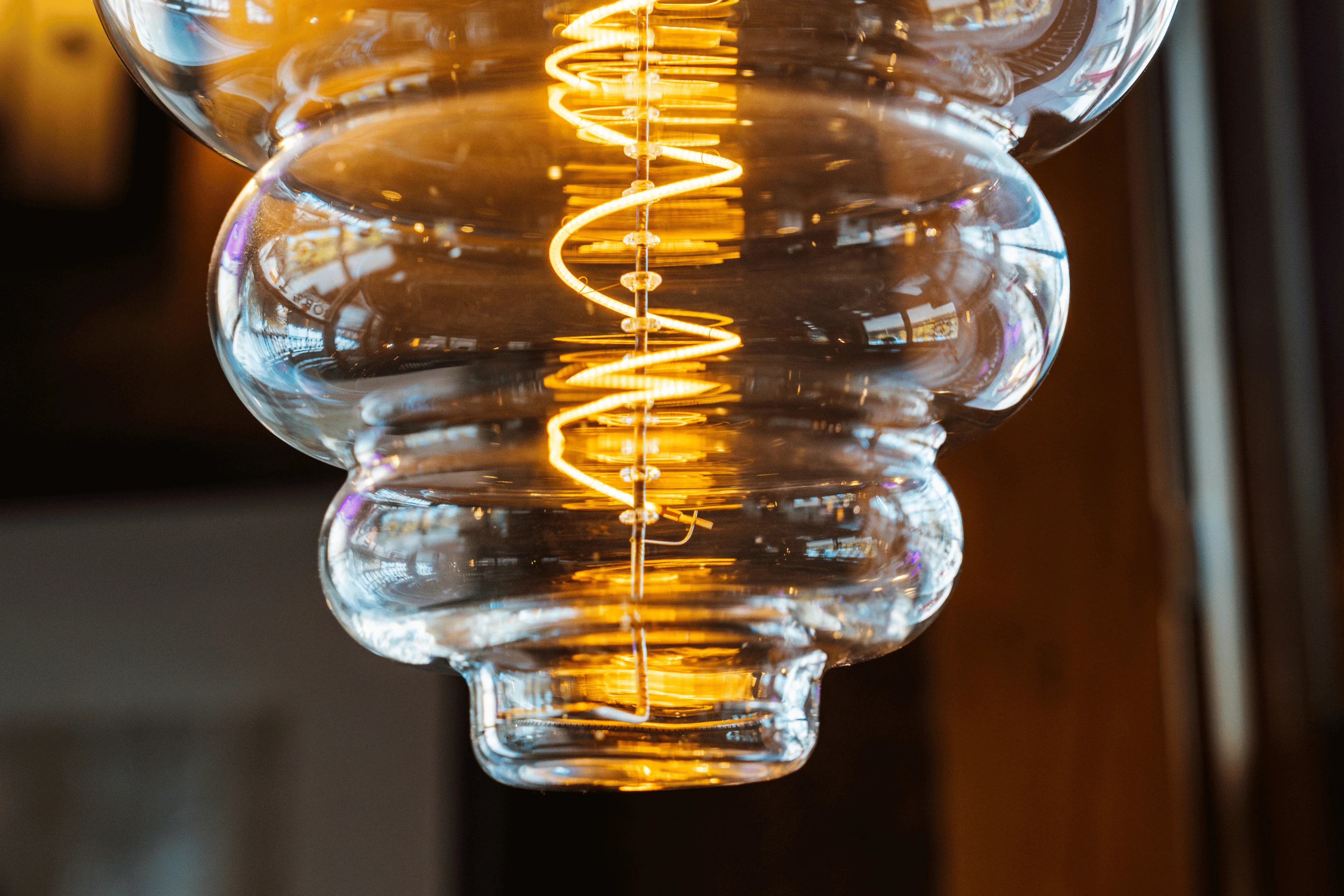 Stylish glass pendant light with warm glowing filament