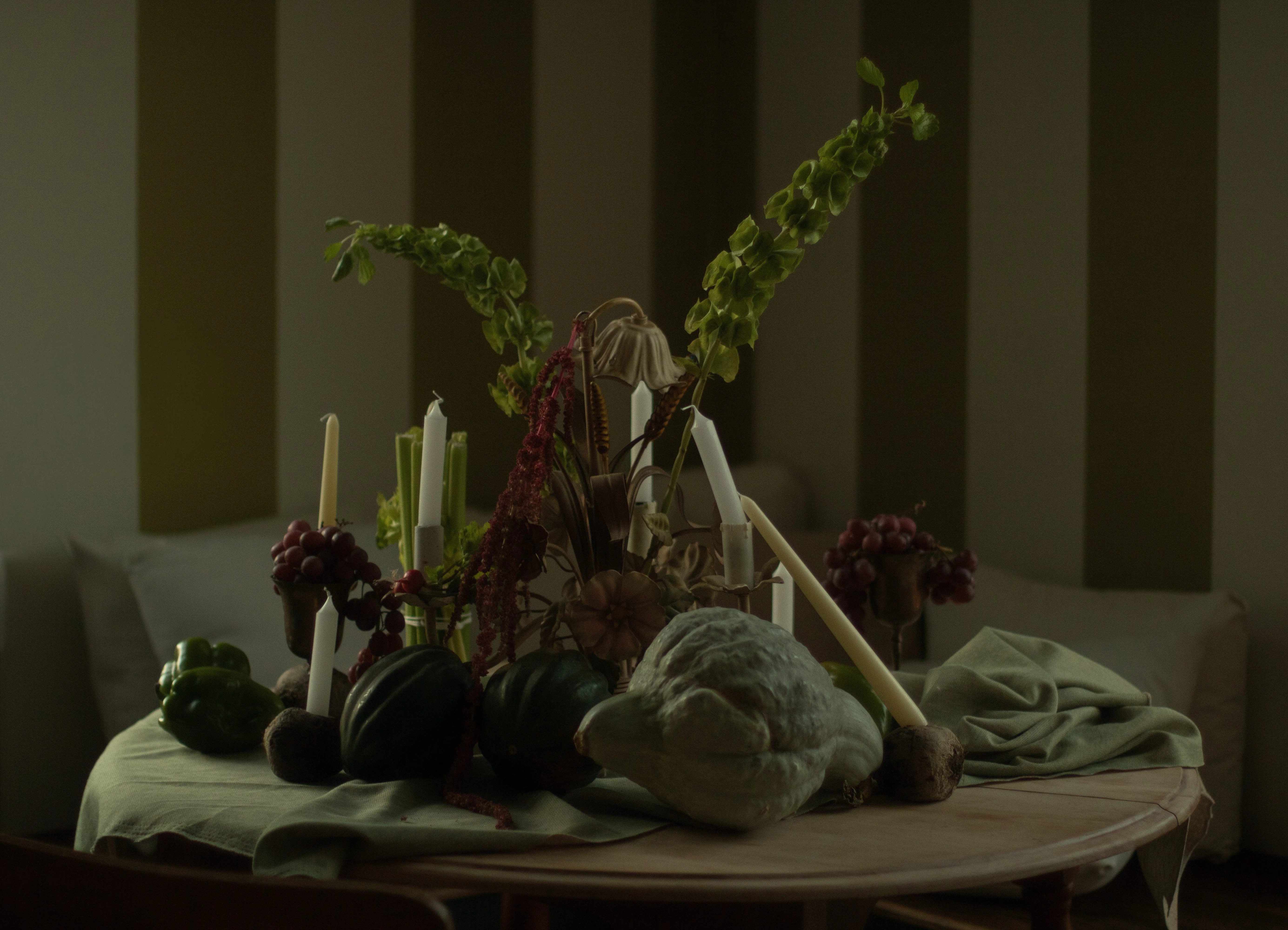 Artistic table arrangement with seasonal vegetables and candles