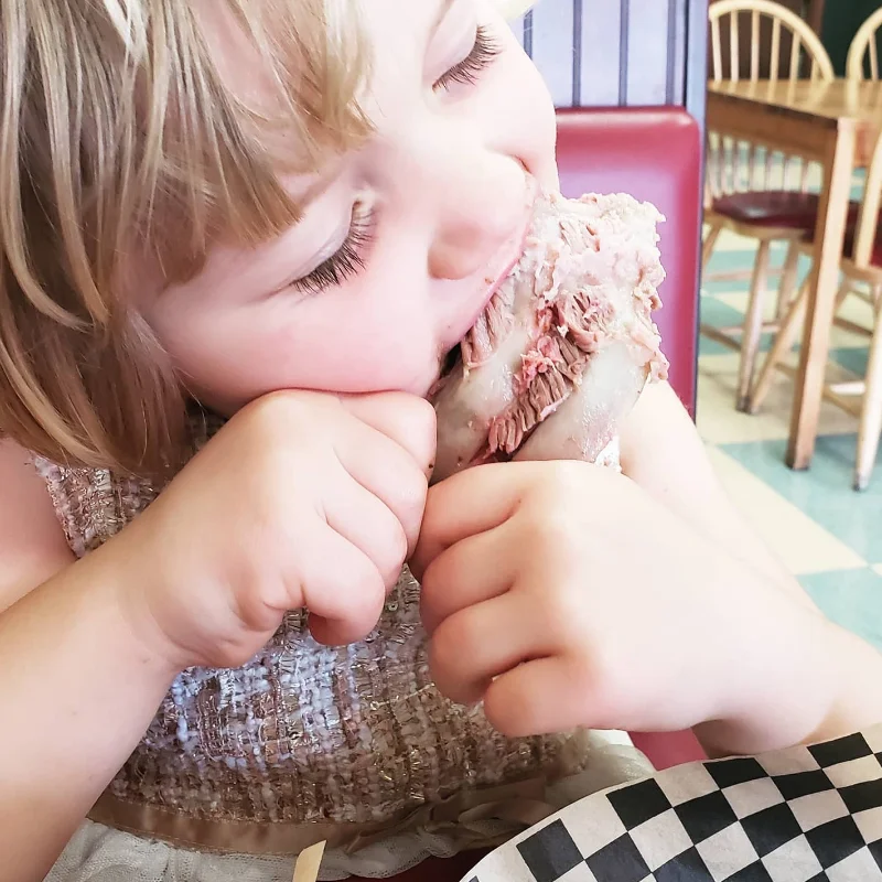 little girl eating rib