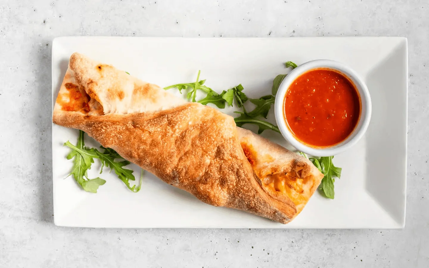 Italian calzone served with marinara sauce