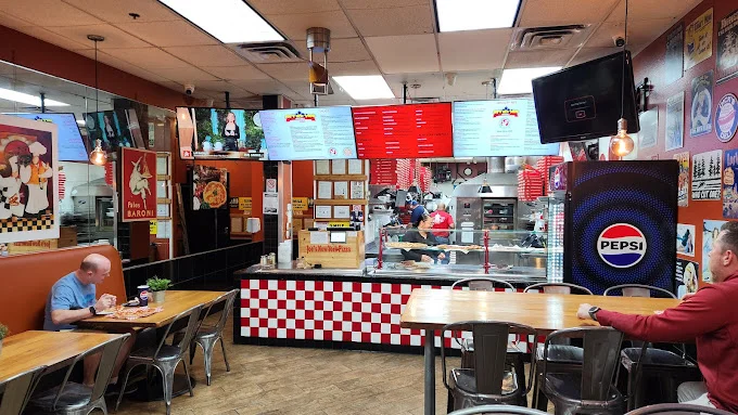 Cozy restaurant interior with checkered decor and menu screens