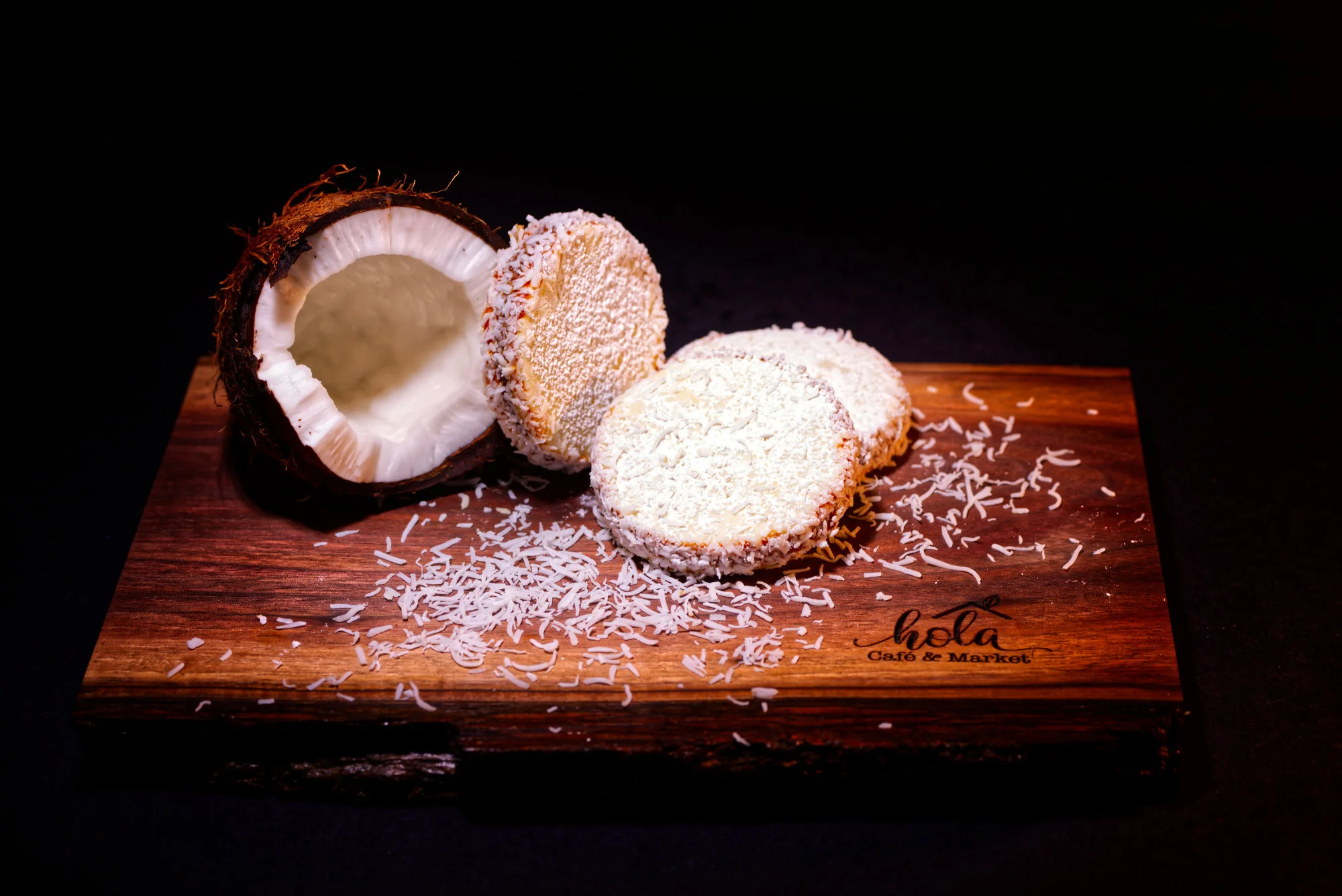 Coconut dessert slices on a wooden board with shredded coconut