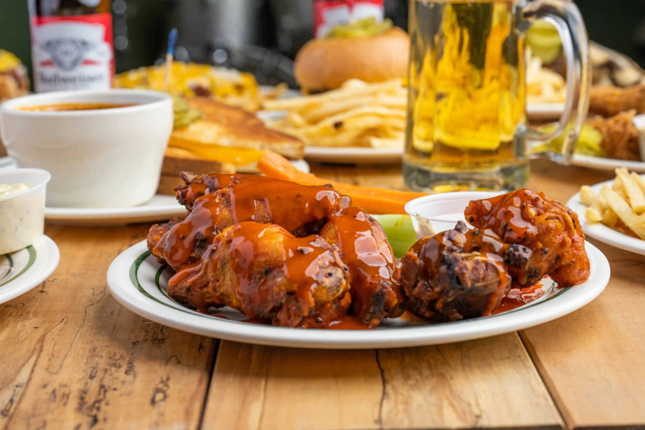 Buffalo chicken wings with spicy sauce and celery sticks