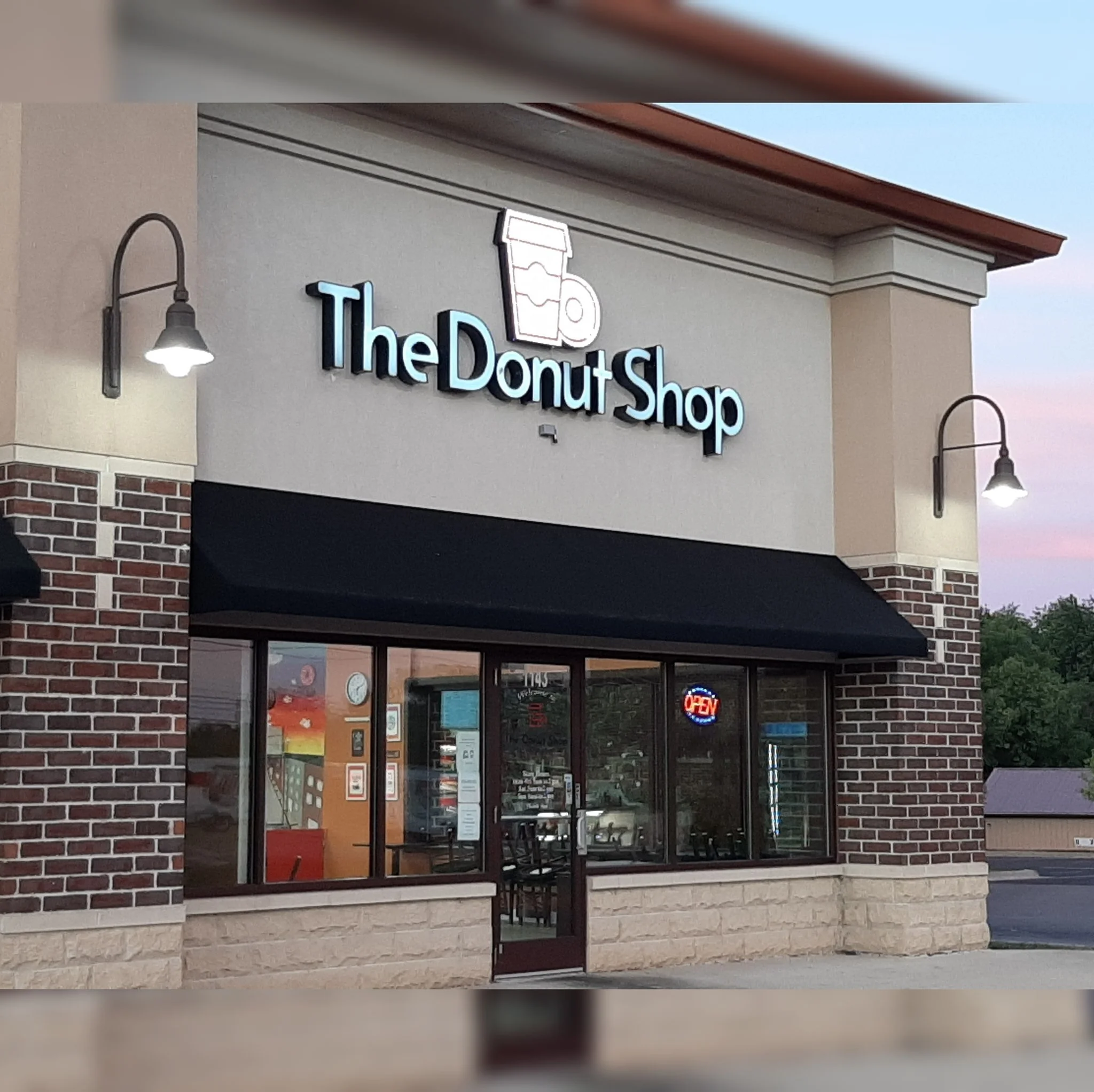 Exterior view of The Donut Shop with open sign