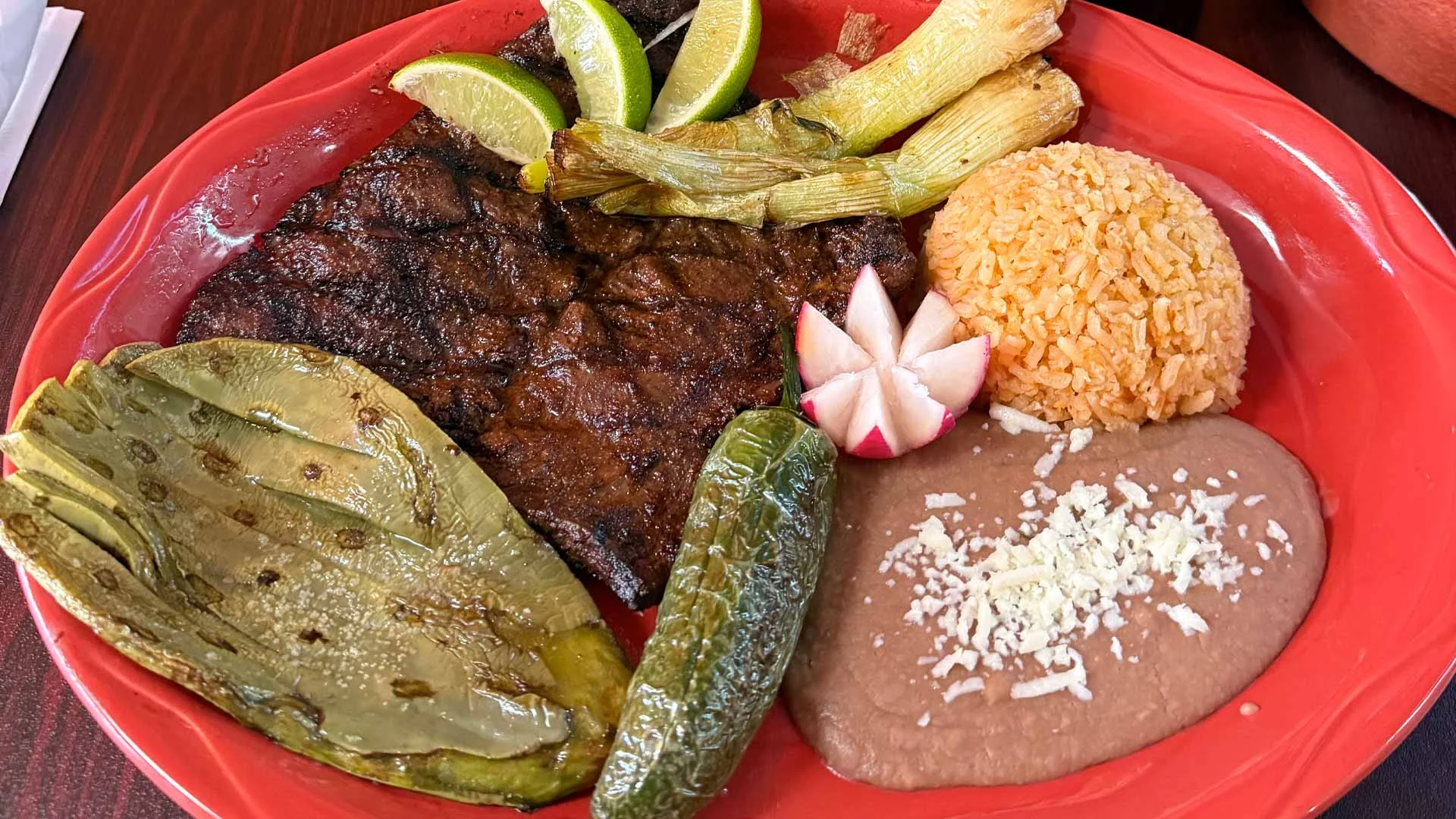 Grilled carne asada plate with rice and beans