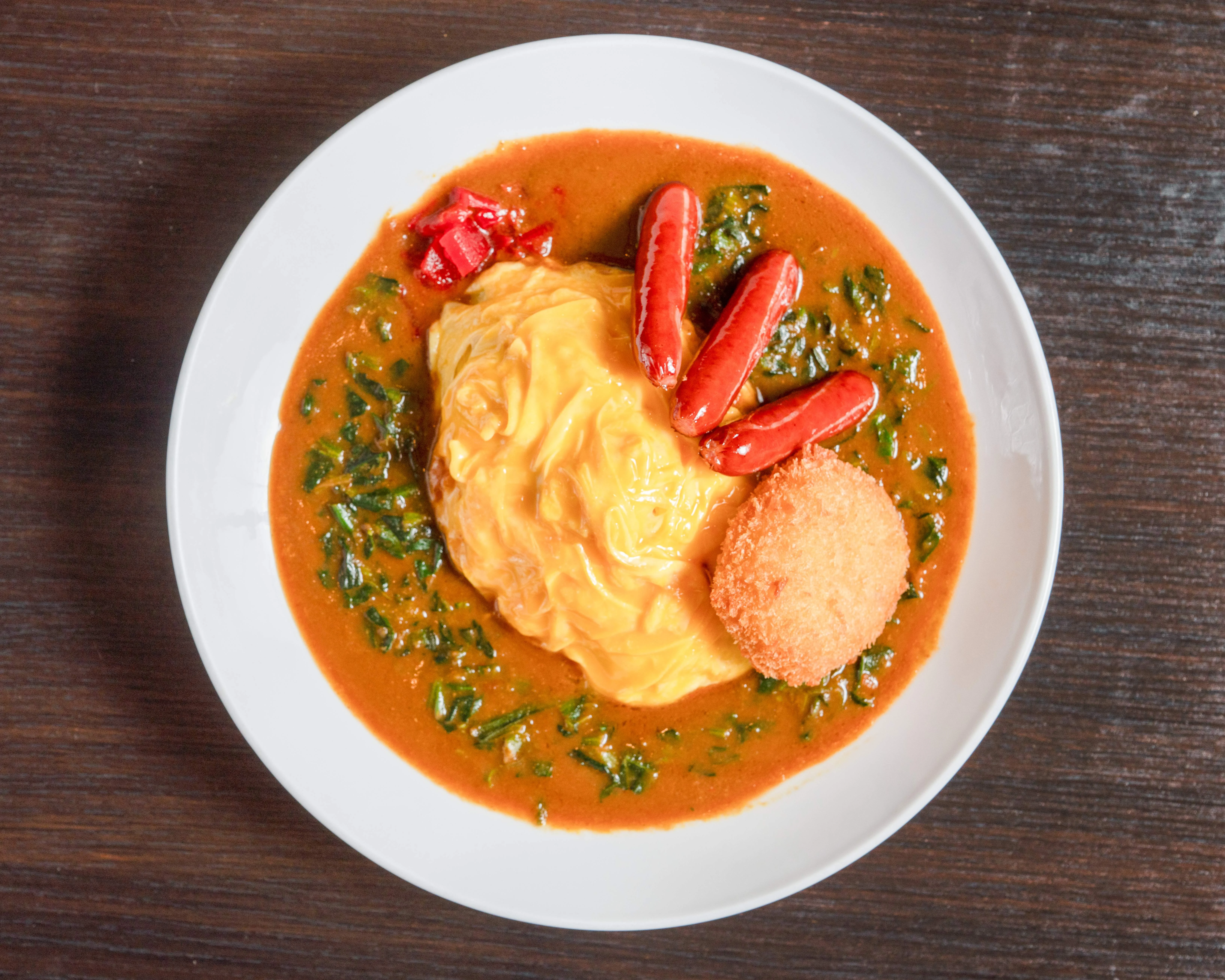 Nigerian jollof rice with eggs and sausages
