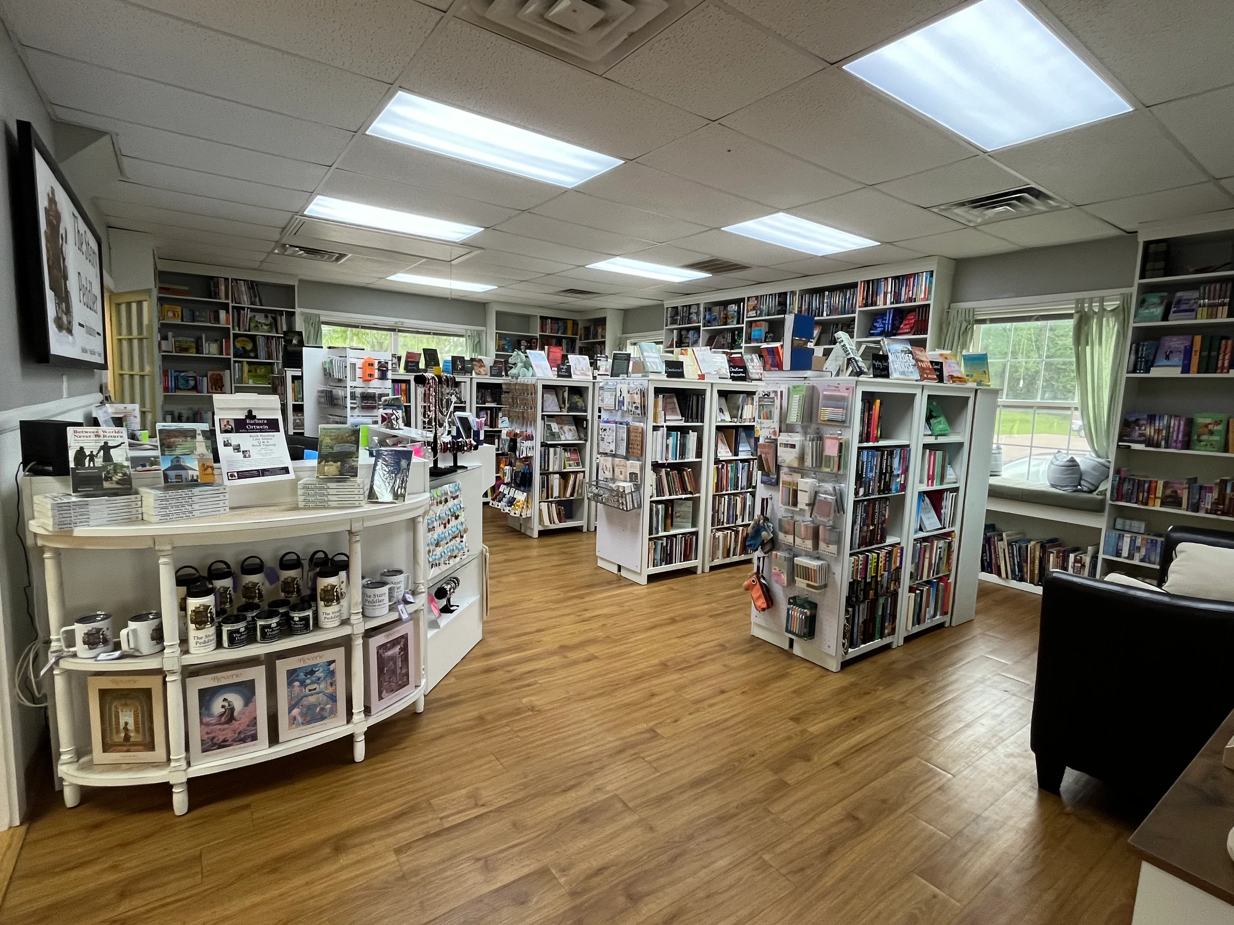 A cozy bookstore interior with shelves filled with books and comfortable seating.