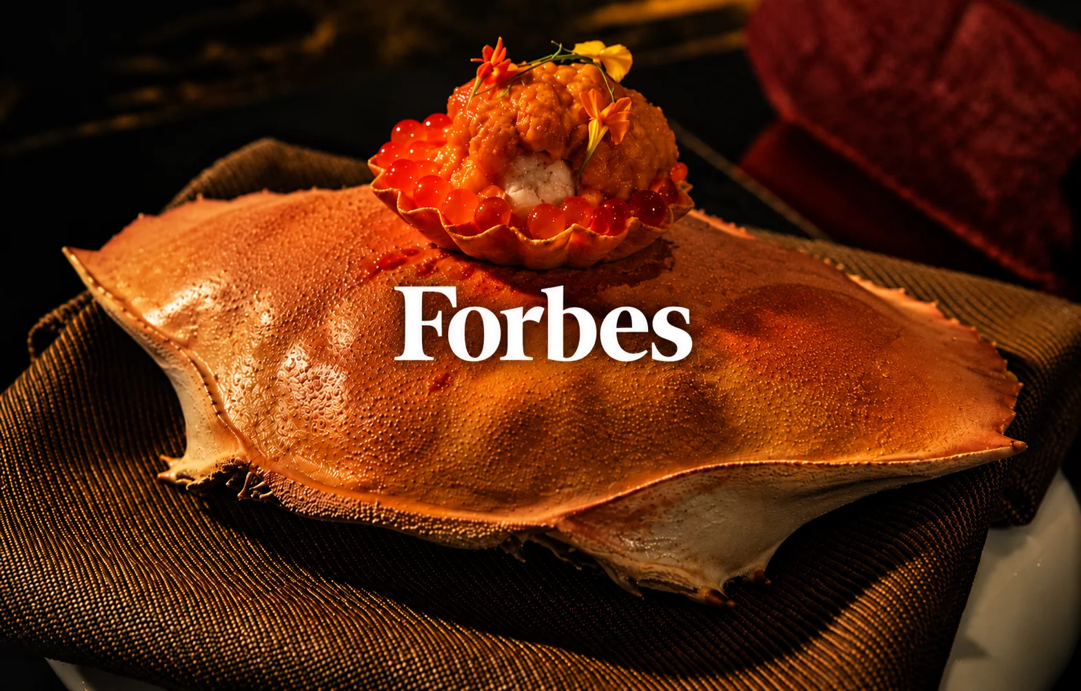 Japanese seafood tart with salmon roe and uni served on a crab shell