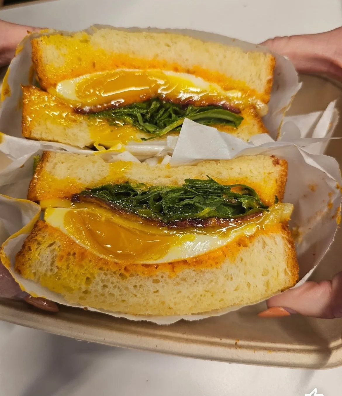 Korean egg sandwich with fresh greens and rich yolk