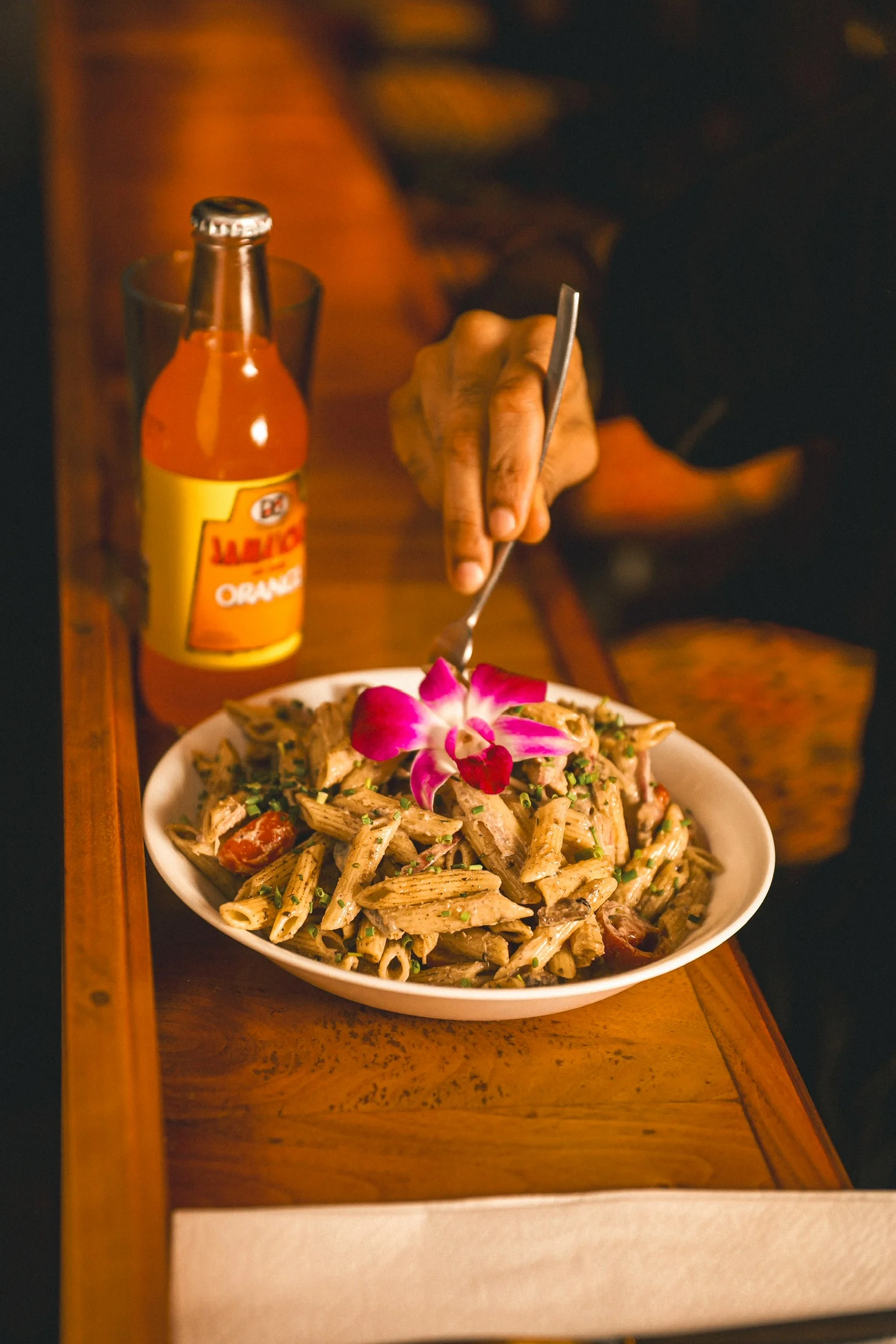 Creamy penne pasta with a floral garnish