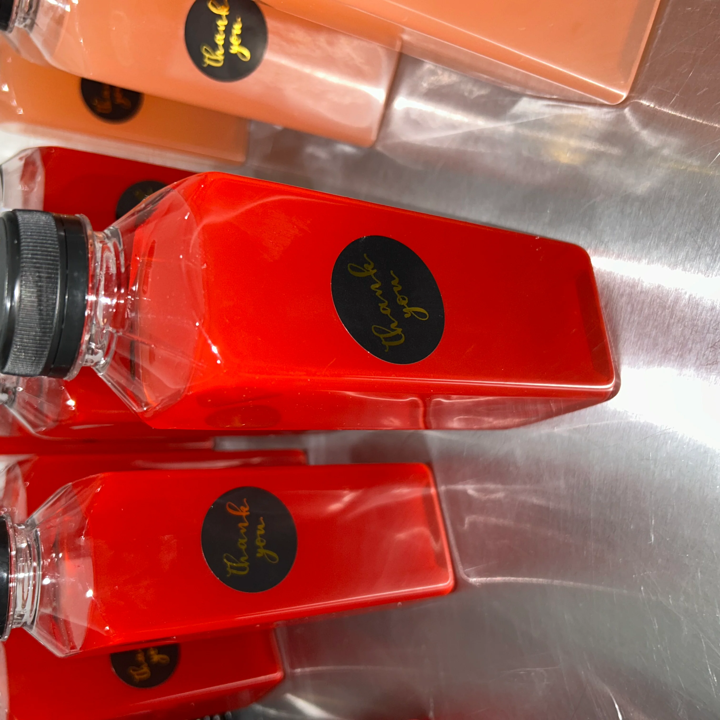 Colorful juice bottles with thank you labels