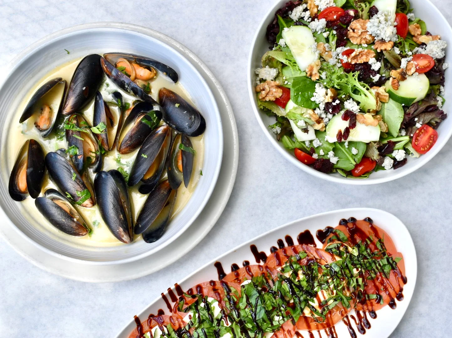 Mussels in white wine sauce with a fresh garden salad and Caprese salad