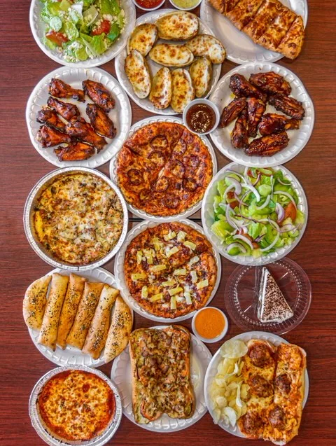 Assorted pizza and wings platter for a casual feast