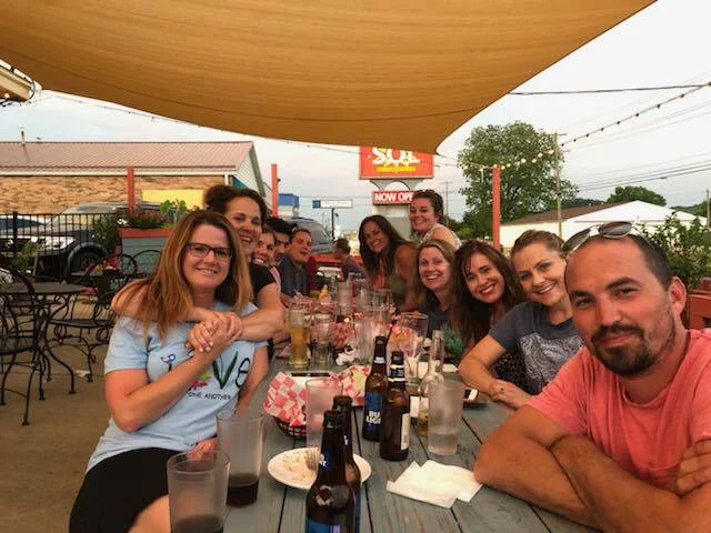 Group of friends enjoying a meal outdoors at a restaurant