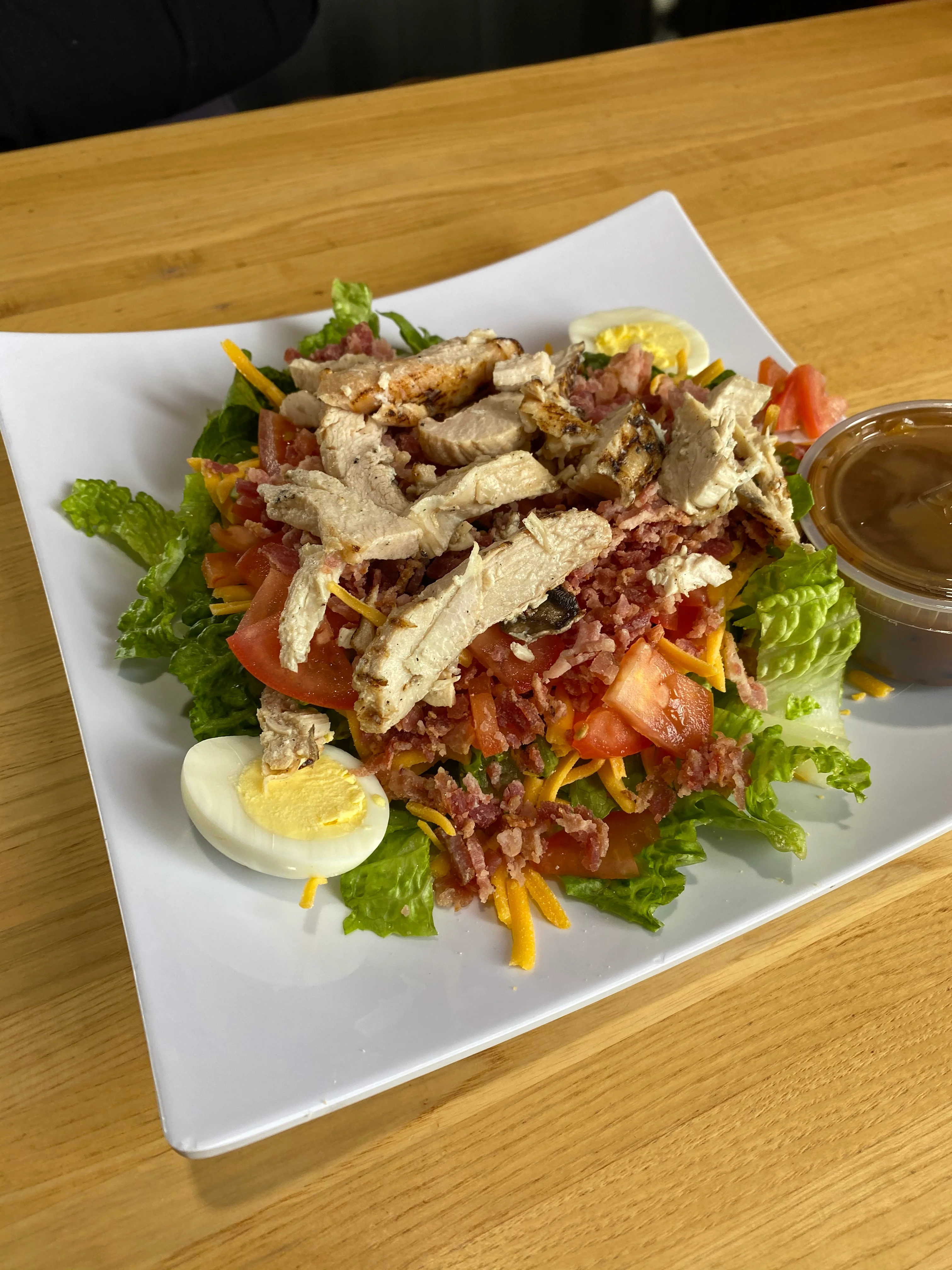 Delicious gourmet burger with fresh toppings on a wooden table