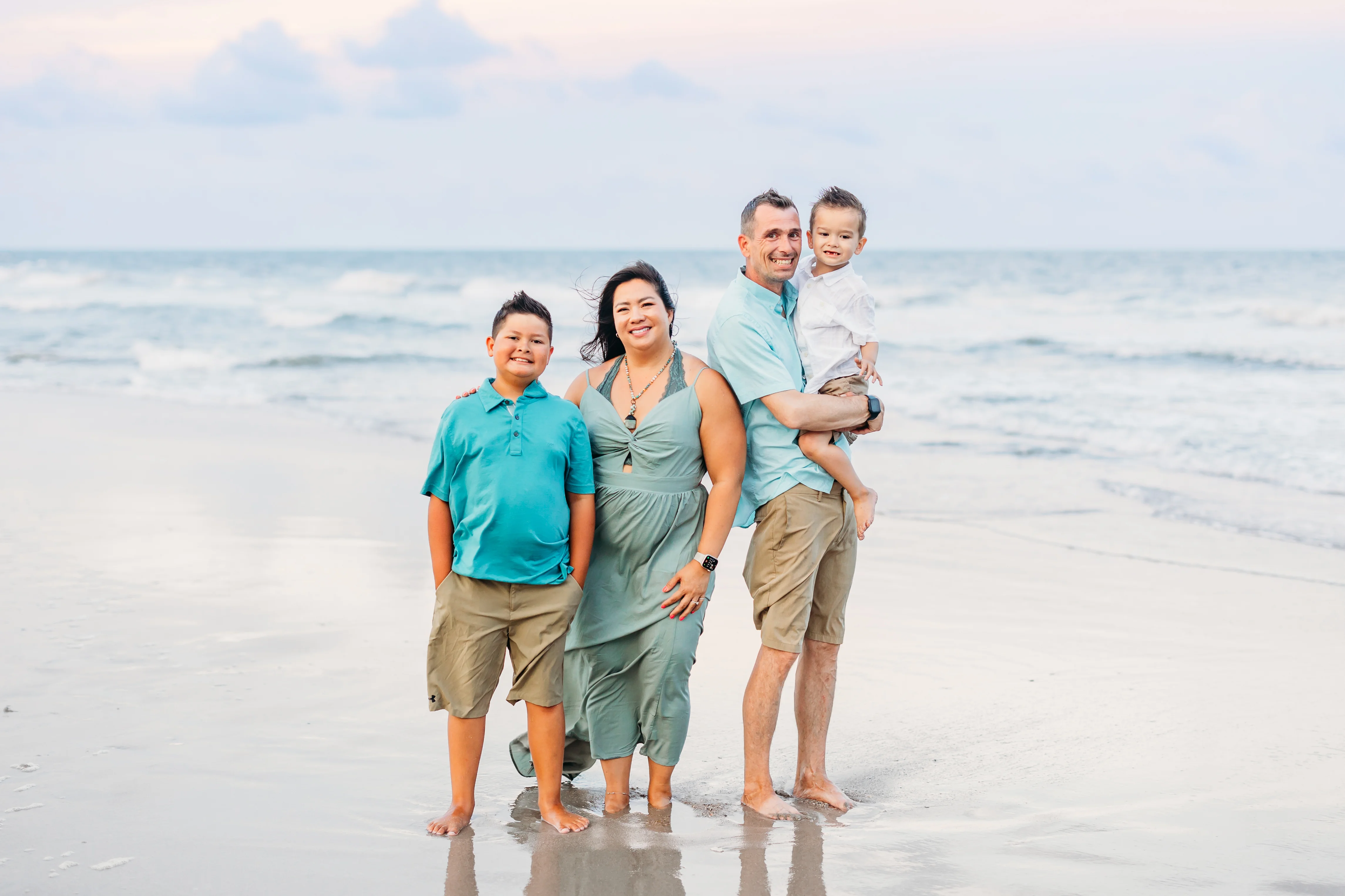 Family portrait on the beach at sunset