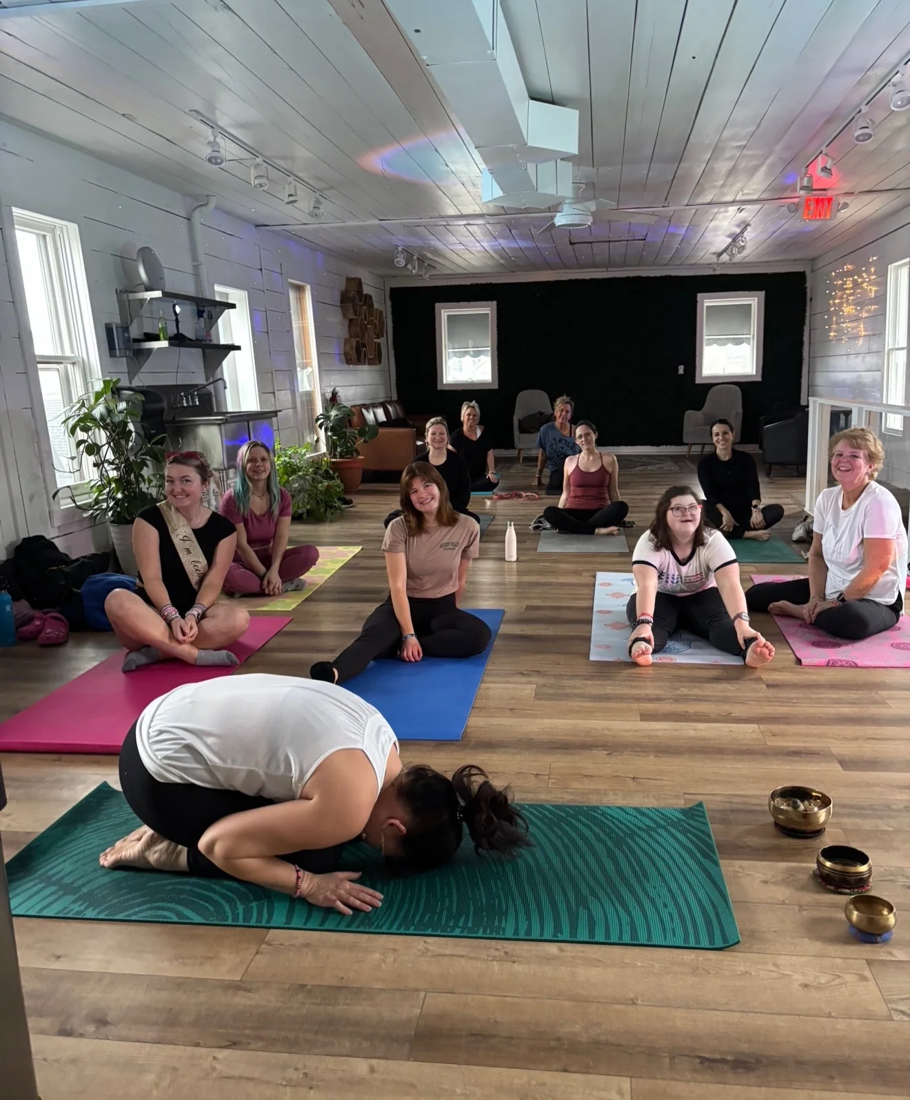 Yoga class in a serene studio with participants on mats