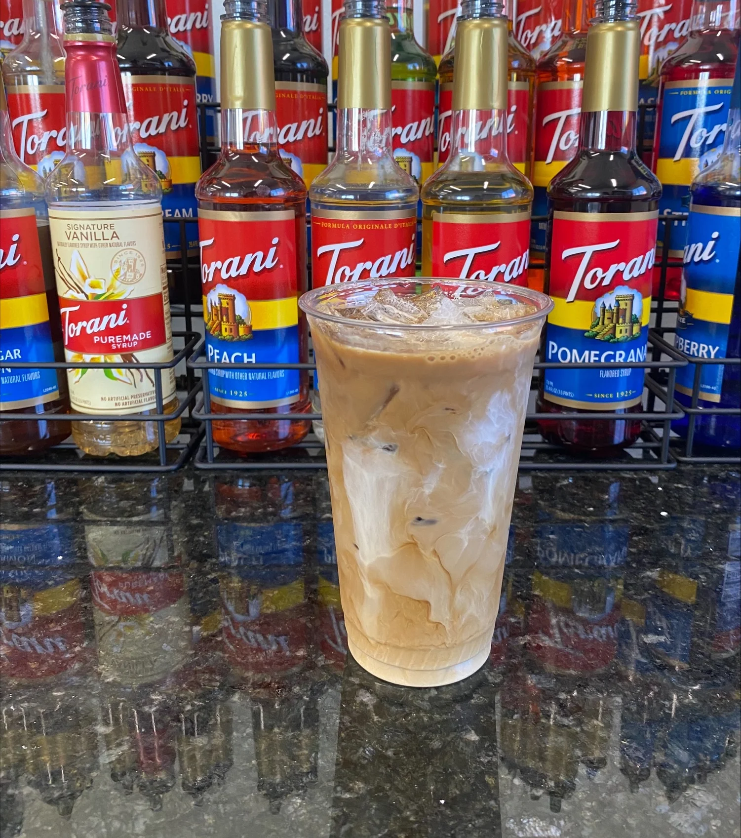Iced coffee drink with creamy swirls and flavored syrups