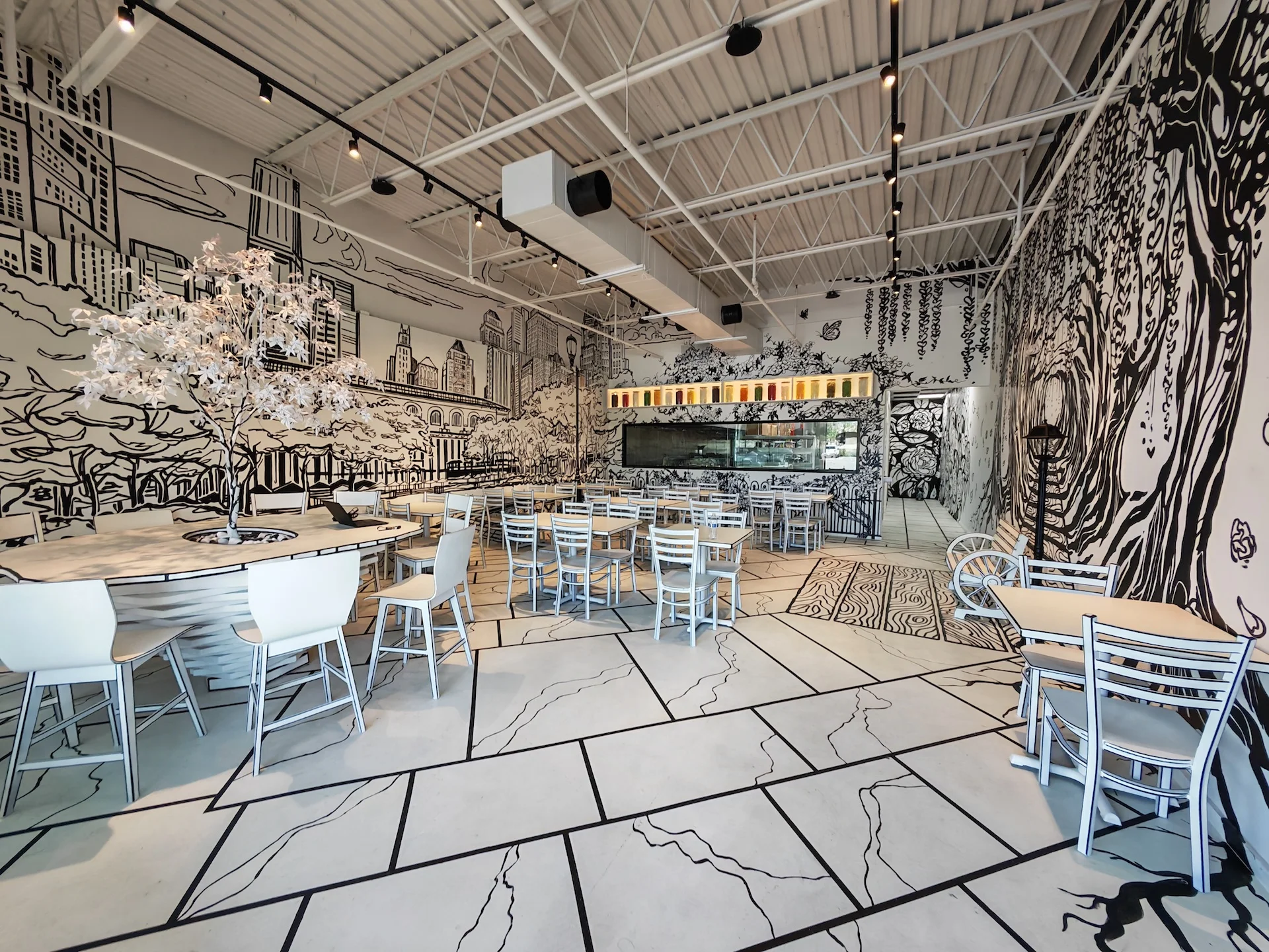 The unique 2-D cartoon-themed interior of Chopsticks Charm, where the walls, tables, and chairs are designed to look like a black and white drawing.