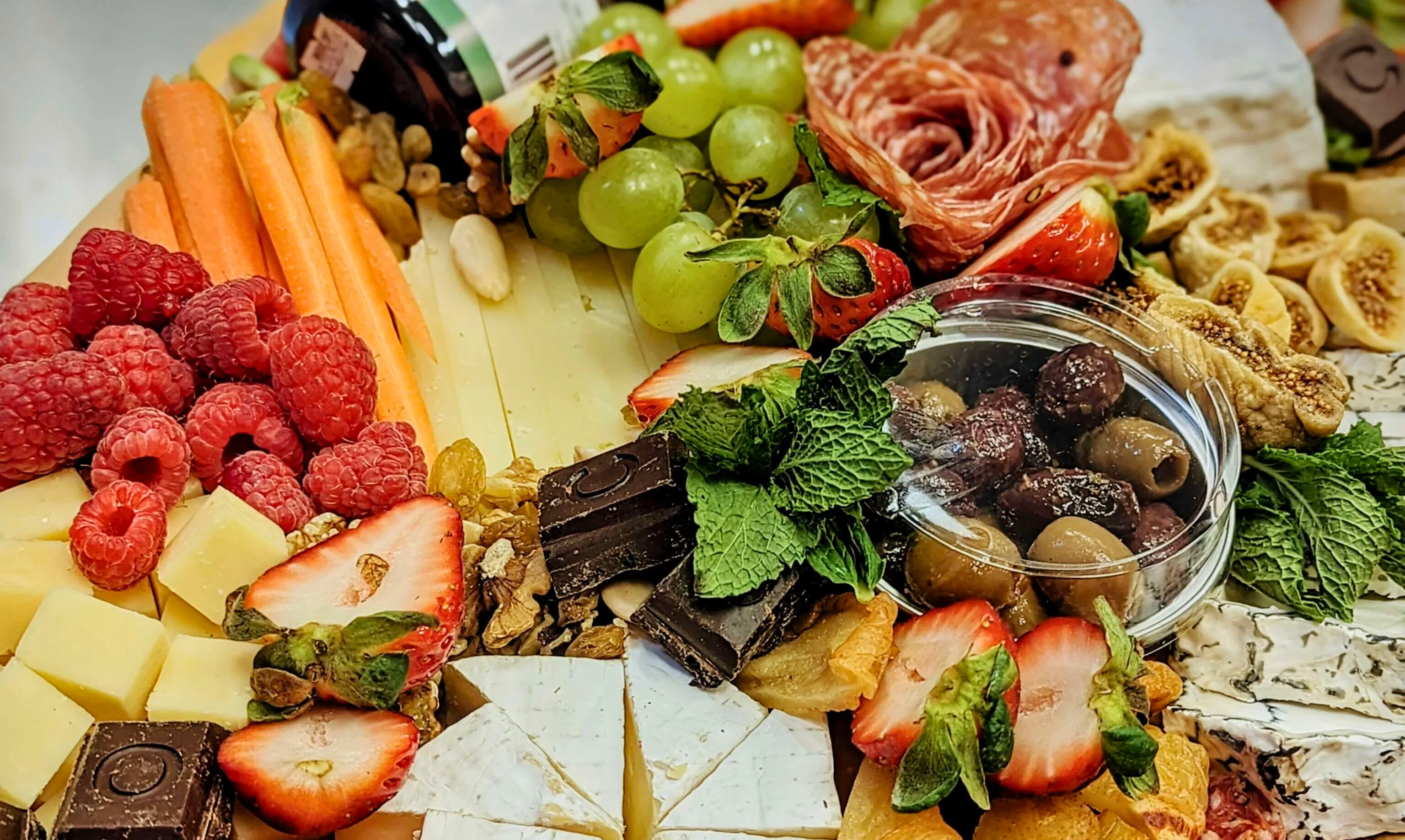 Artisan cheese and charcuterie board with fresh fruits