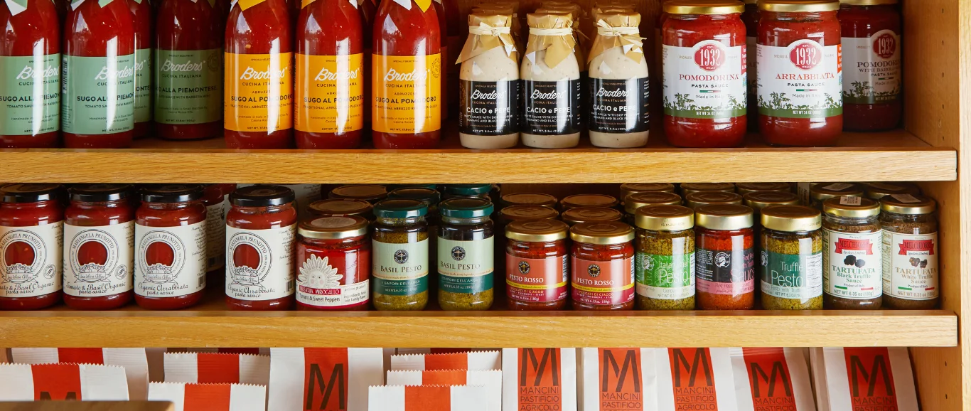 Italian pasta sauces and condiments on wooden shelves