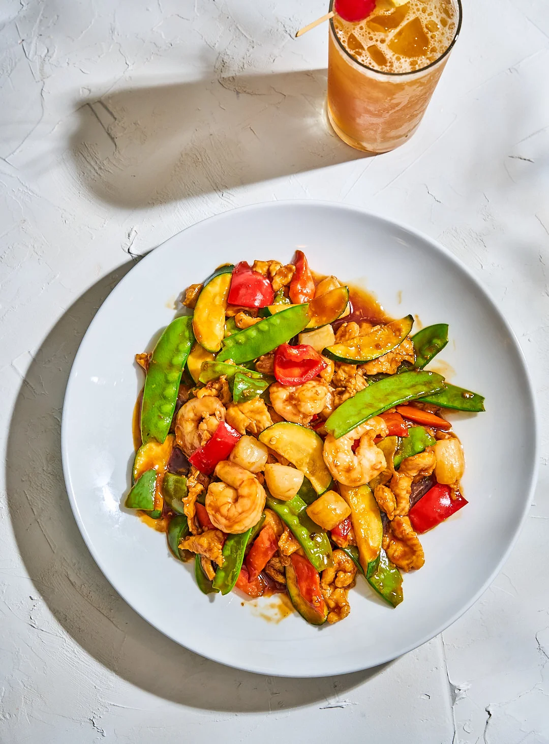 Colorful shrimp stir-fry with vegetables in a white bowl