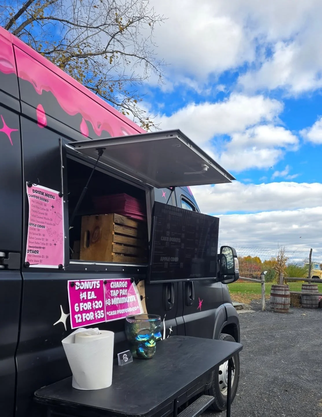 Colorful food truck serving donuts and drinks outdoors