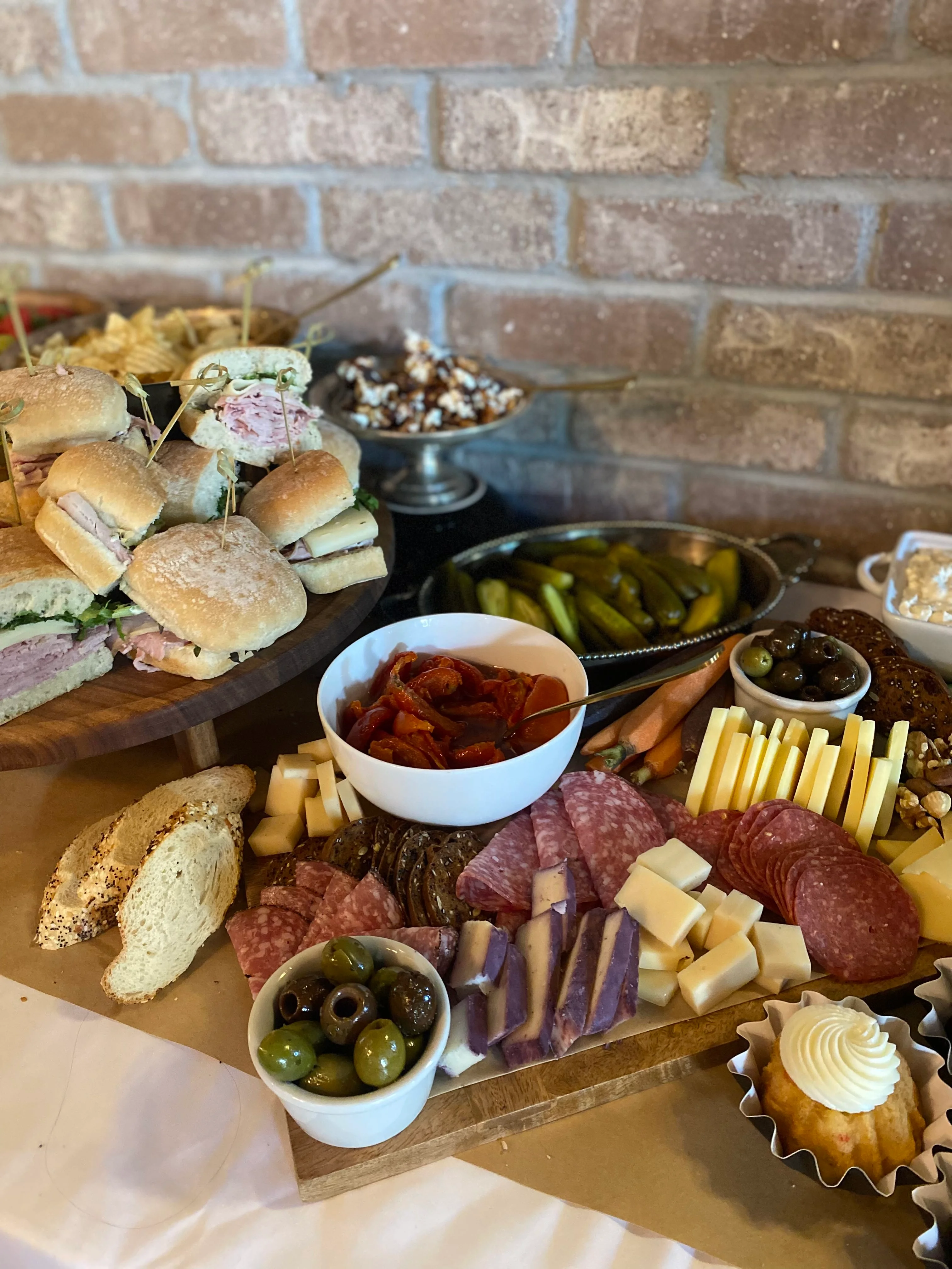 Assorted charcuterie platter with sandwiches and pickles