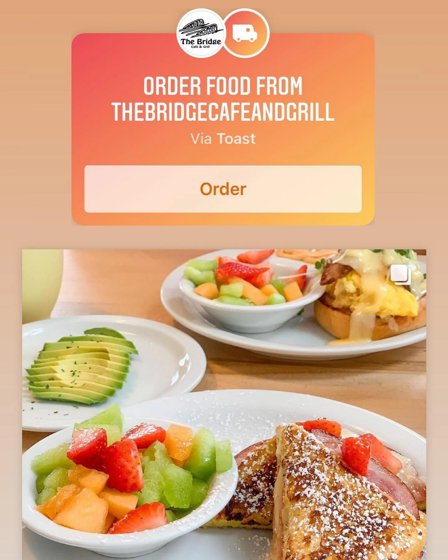 A delicious breakfast spread featuring fresh fruit, avocado slices, and French toast, presented beautifully on a wooden table.