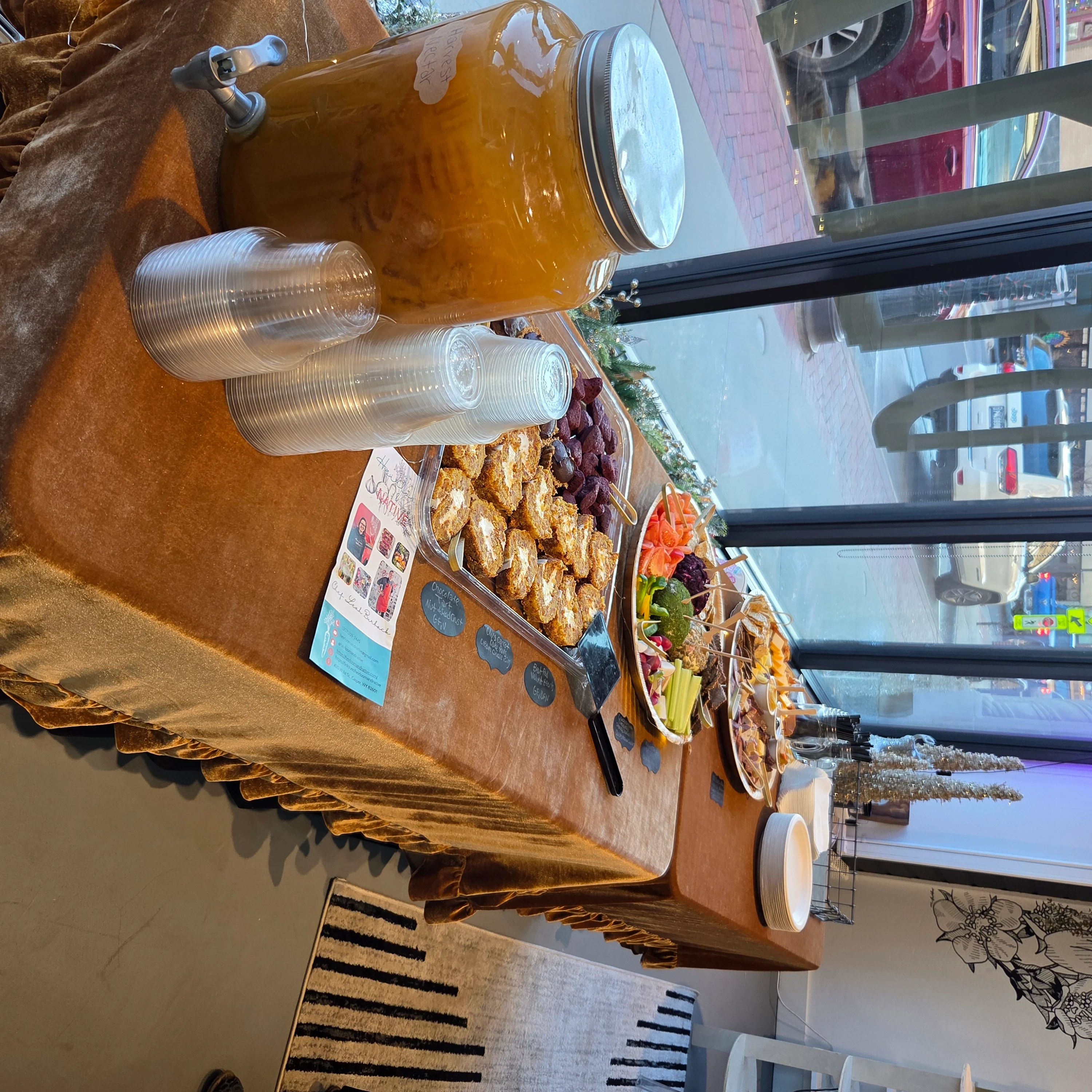 Buffet table with assorted appetizers and drinks in a cozy restaurant setting