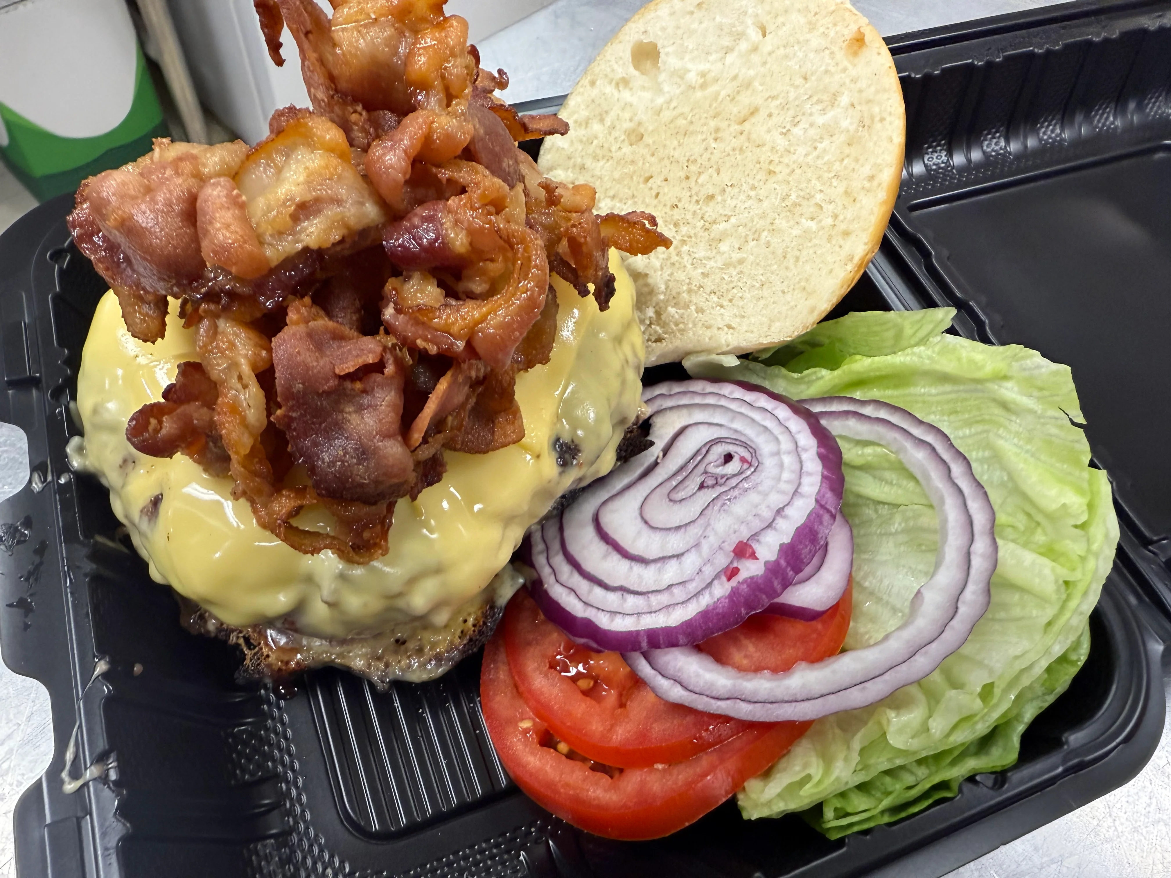 Monster 1 pound bacon cheeseburger with lettuce, tomato onion as a deluxe burger